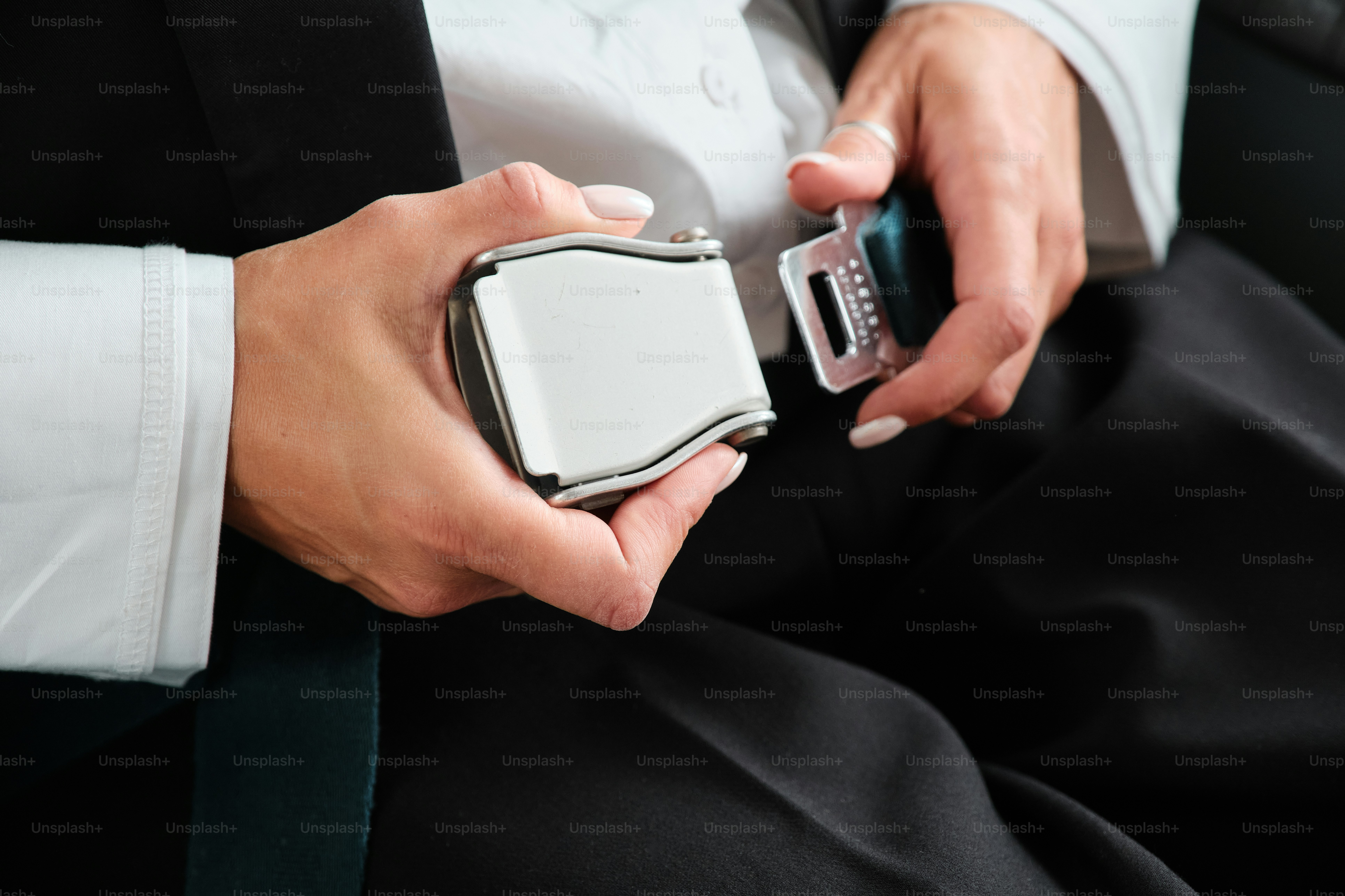 A man in a tuxedo holding a cell phone