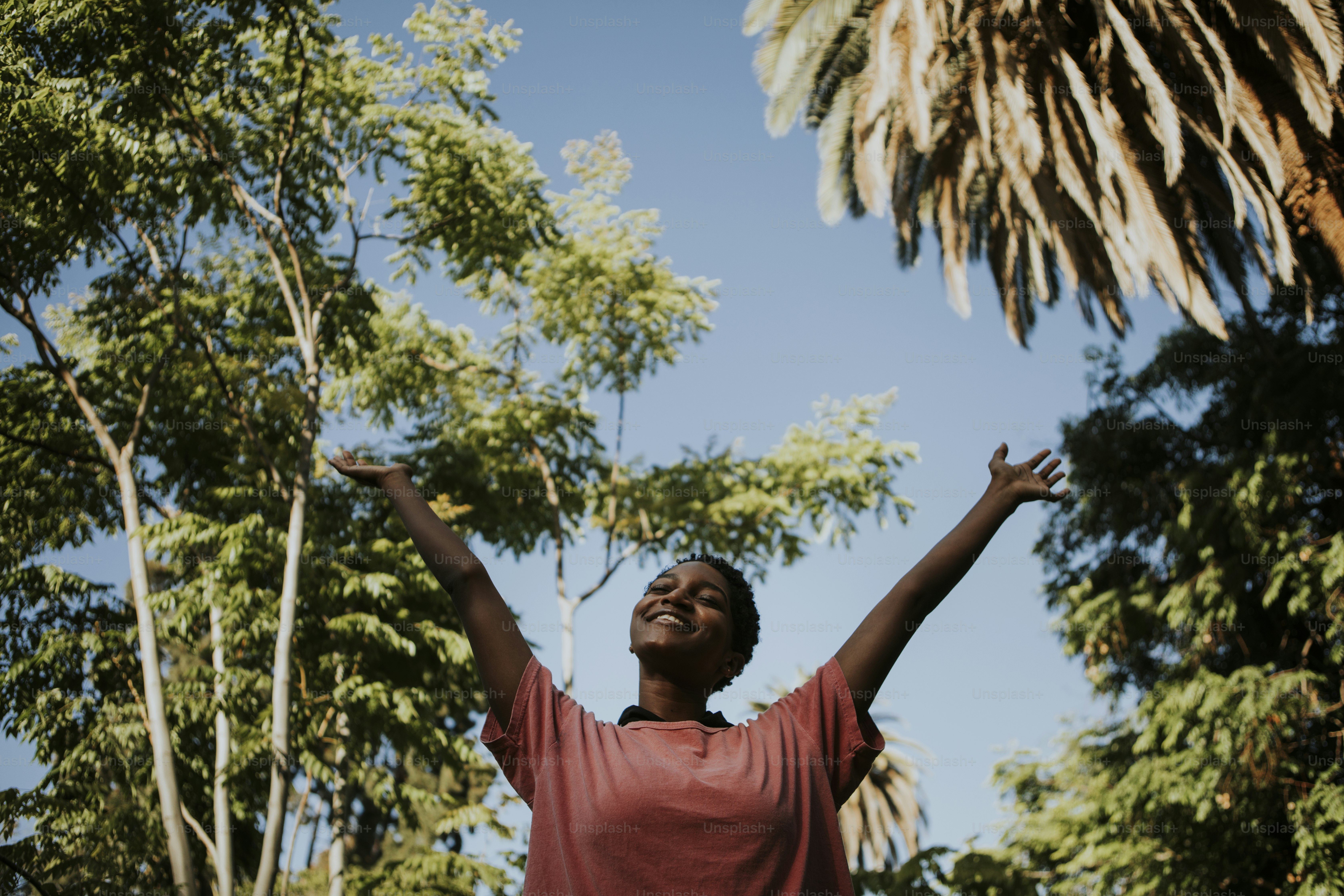 Happy woman feeling free in the park