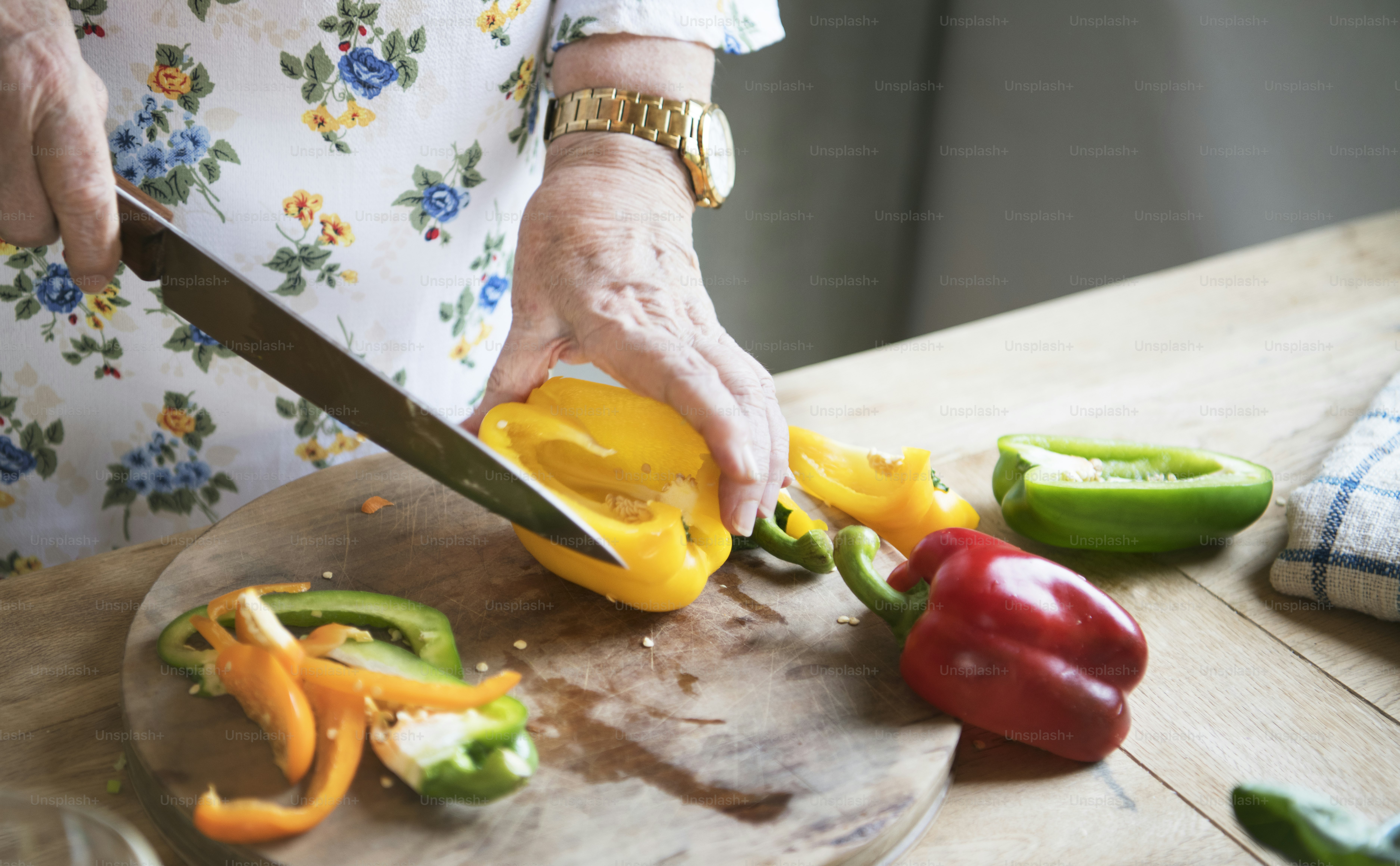 Elderly woman slicing bell peppers