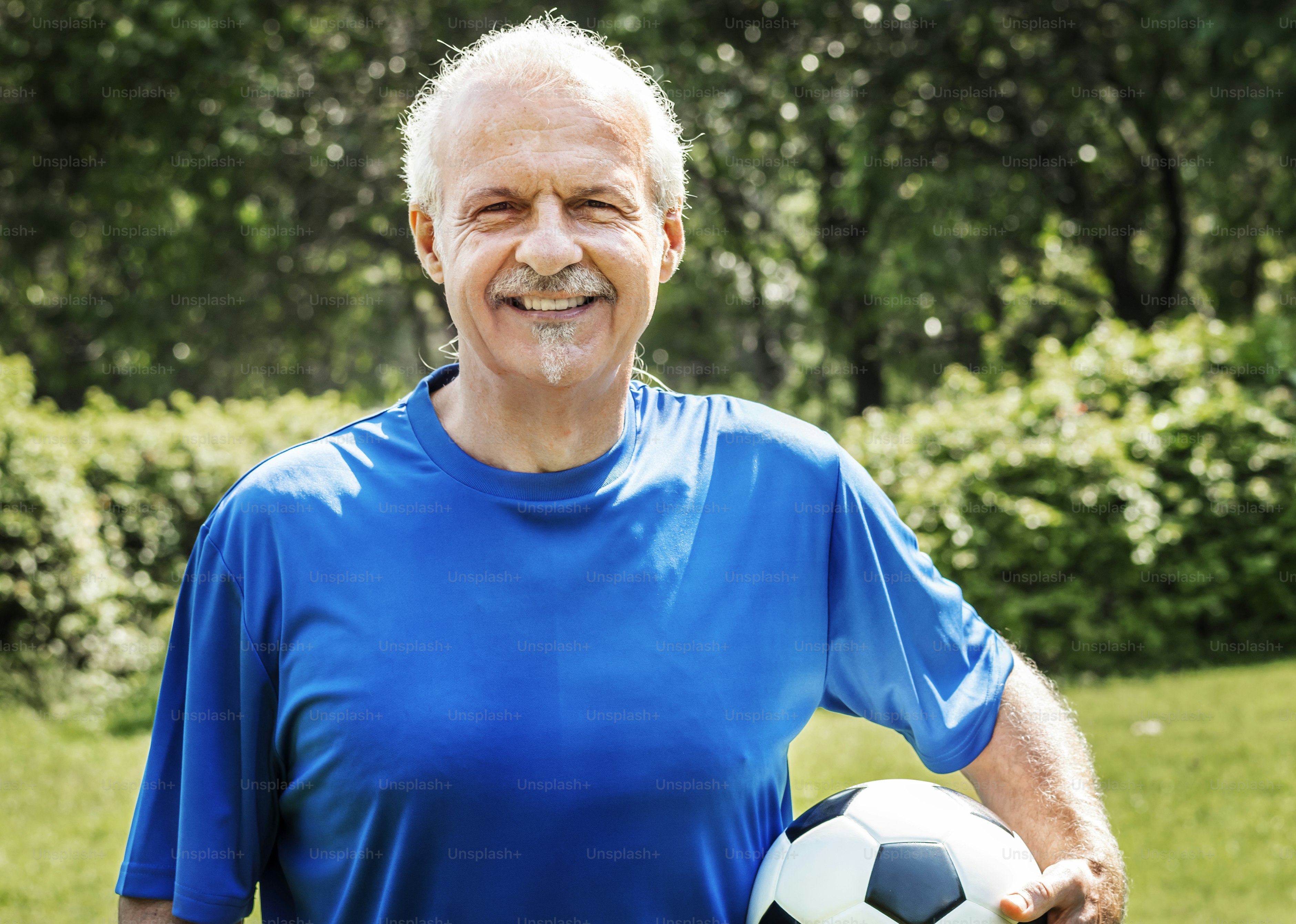 Mature man holding a football