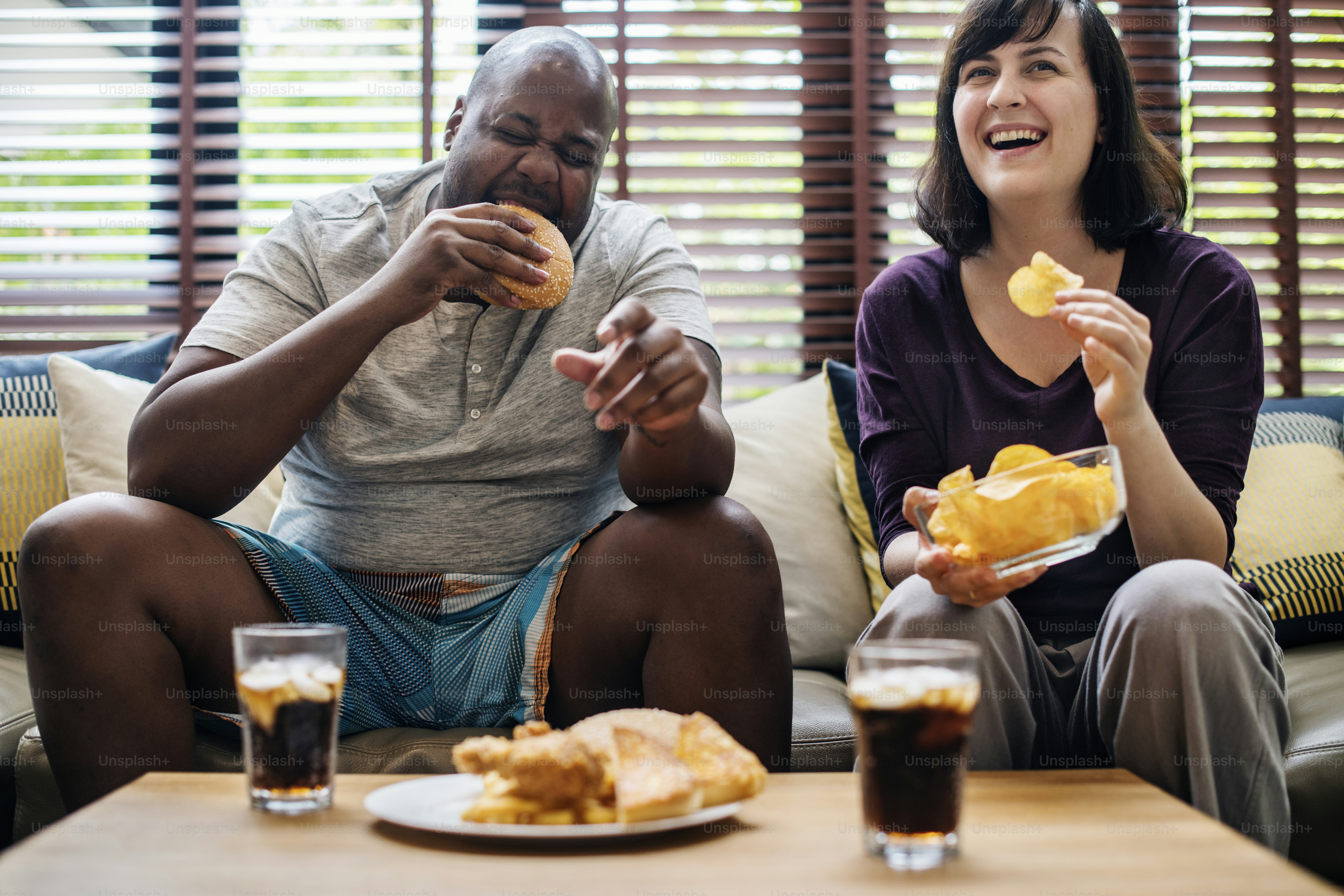 Couple having fast food on the couch