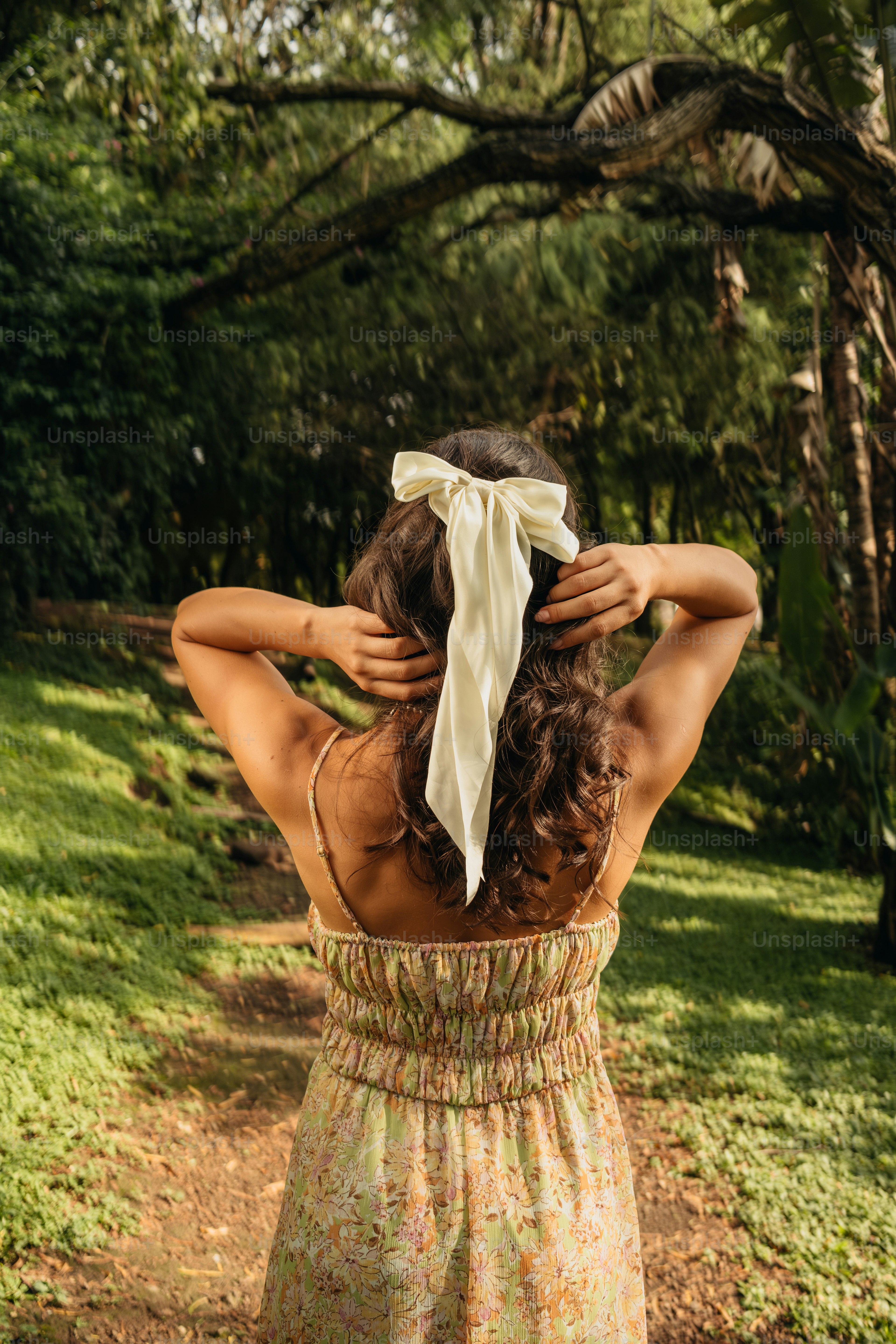 A woman in a dress is standing in the grass