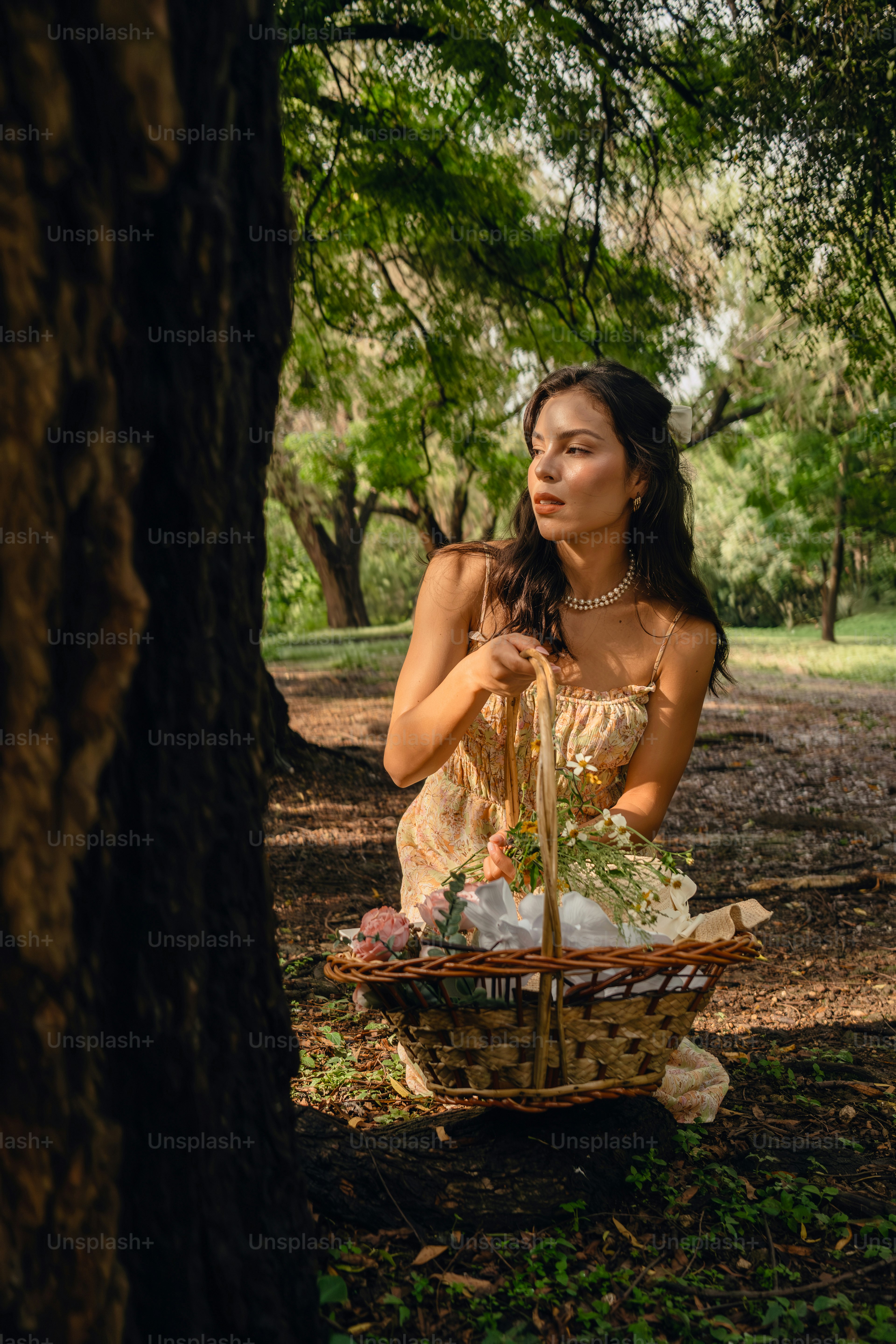 A woman in a dress holding a basket in the woods