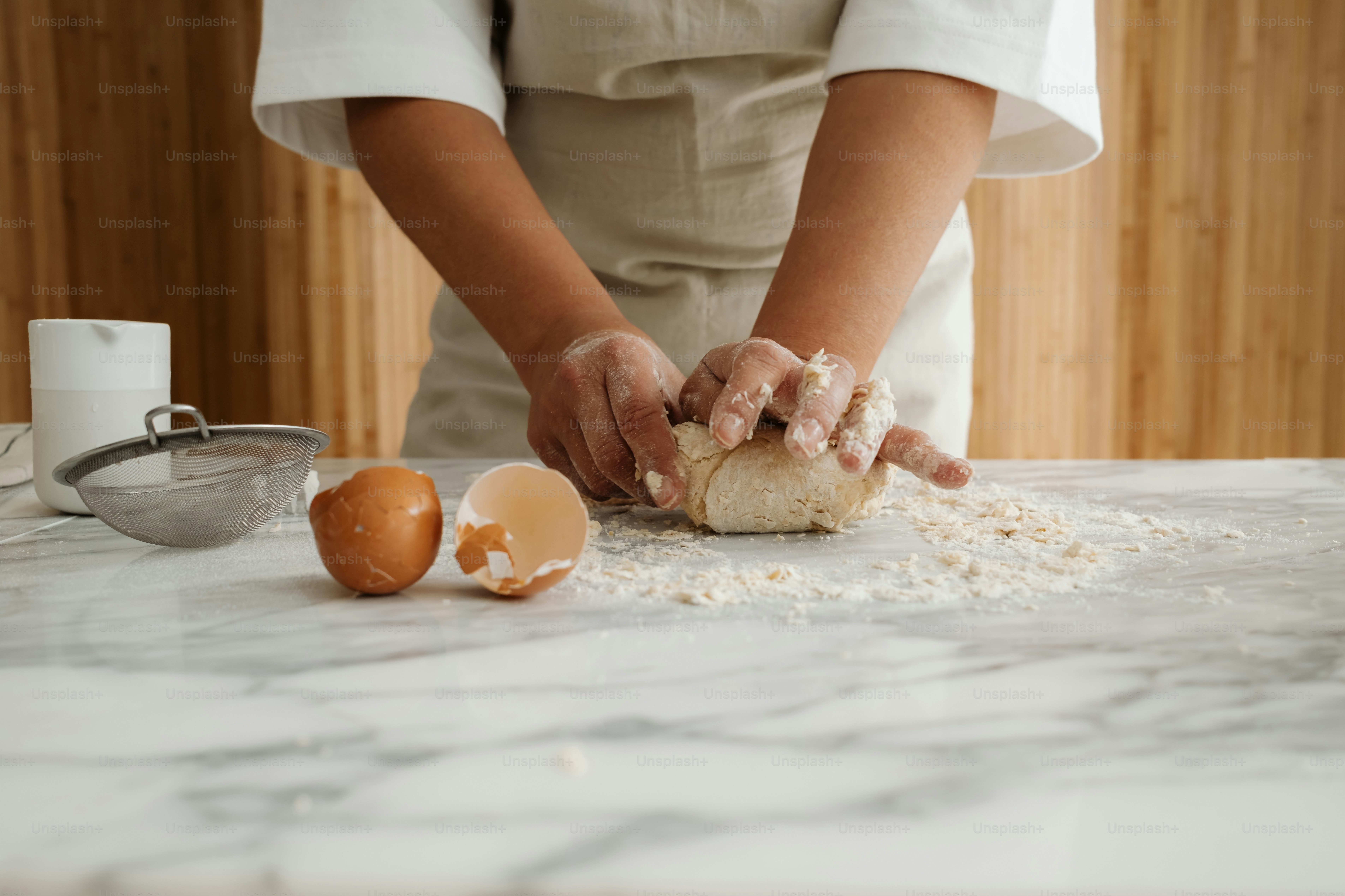 A person in a kitchen preparing food on a counter photo – Food ...