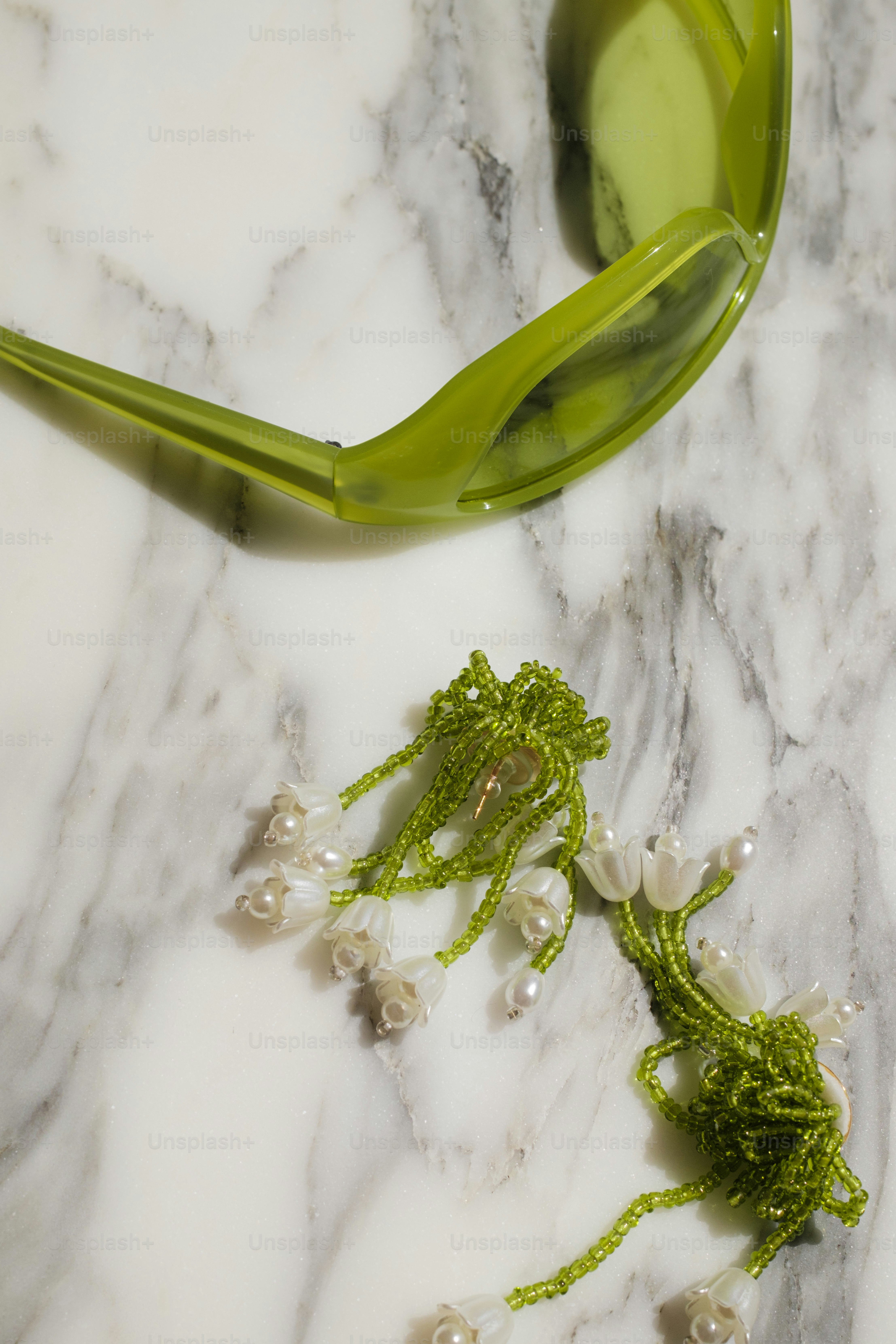 A marble table with a green spoon and flowers on it