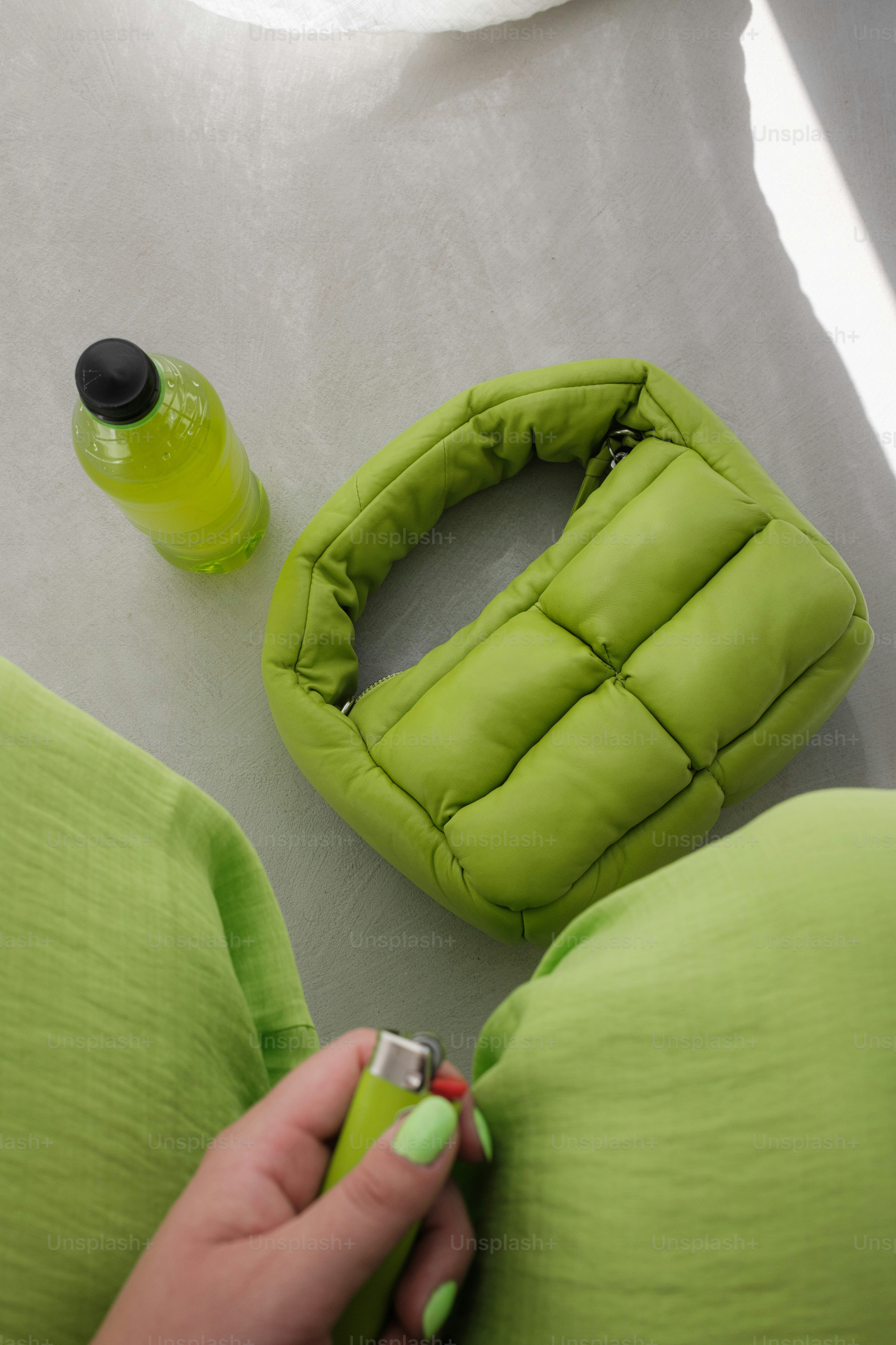 A woman in a green dress is holding a green object