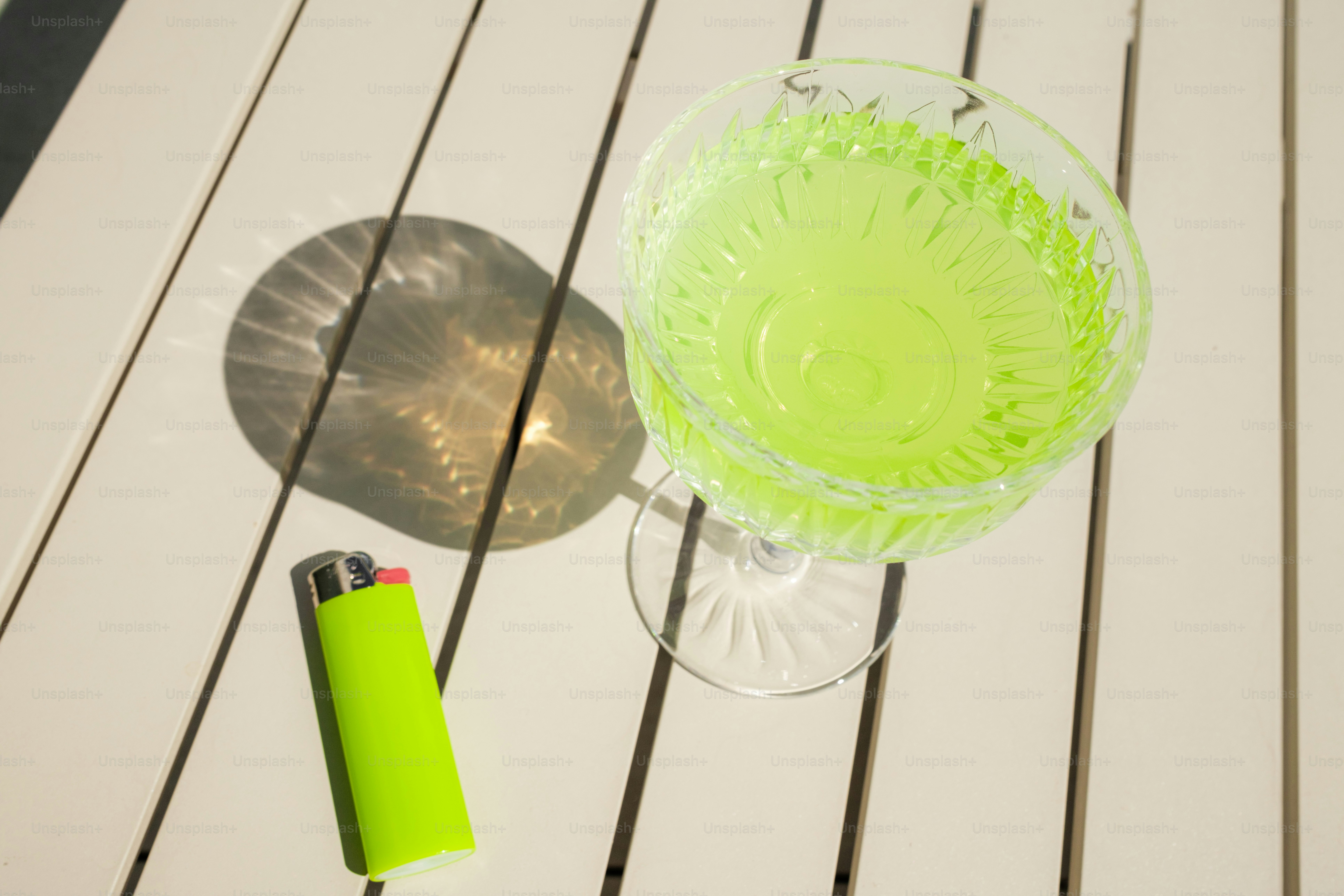 A green drink sitting on top of a wooden table