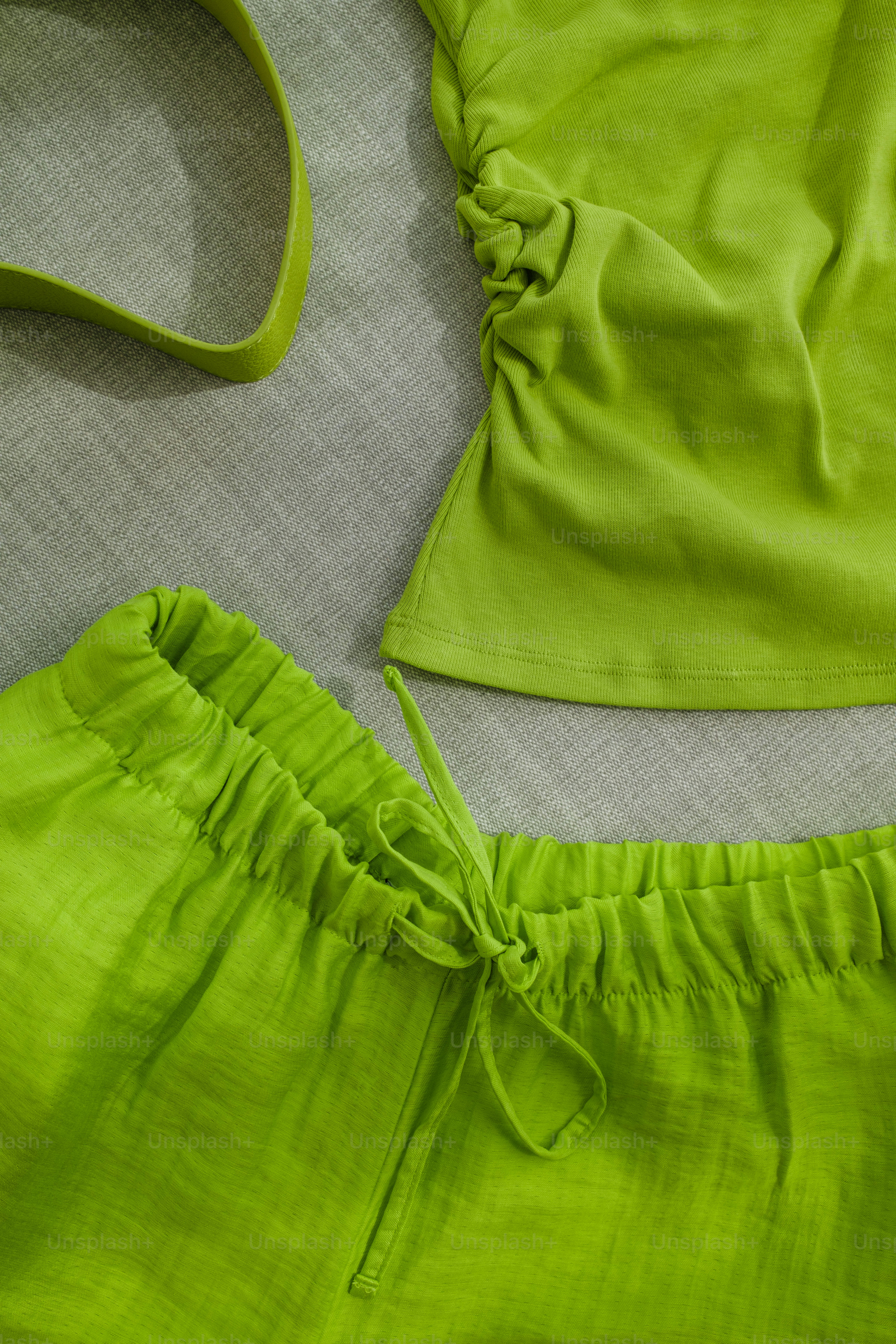 A woman's top and shorts laying on a bed