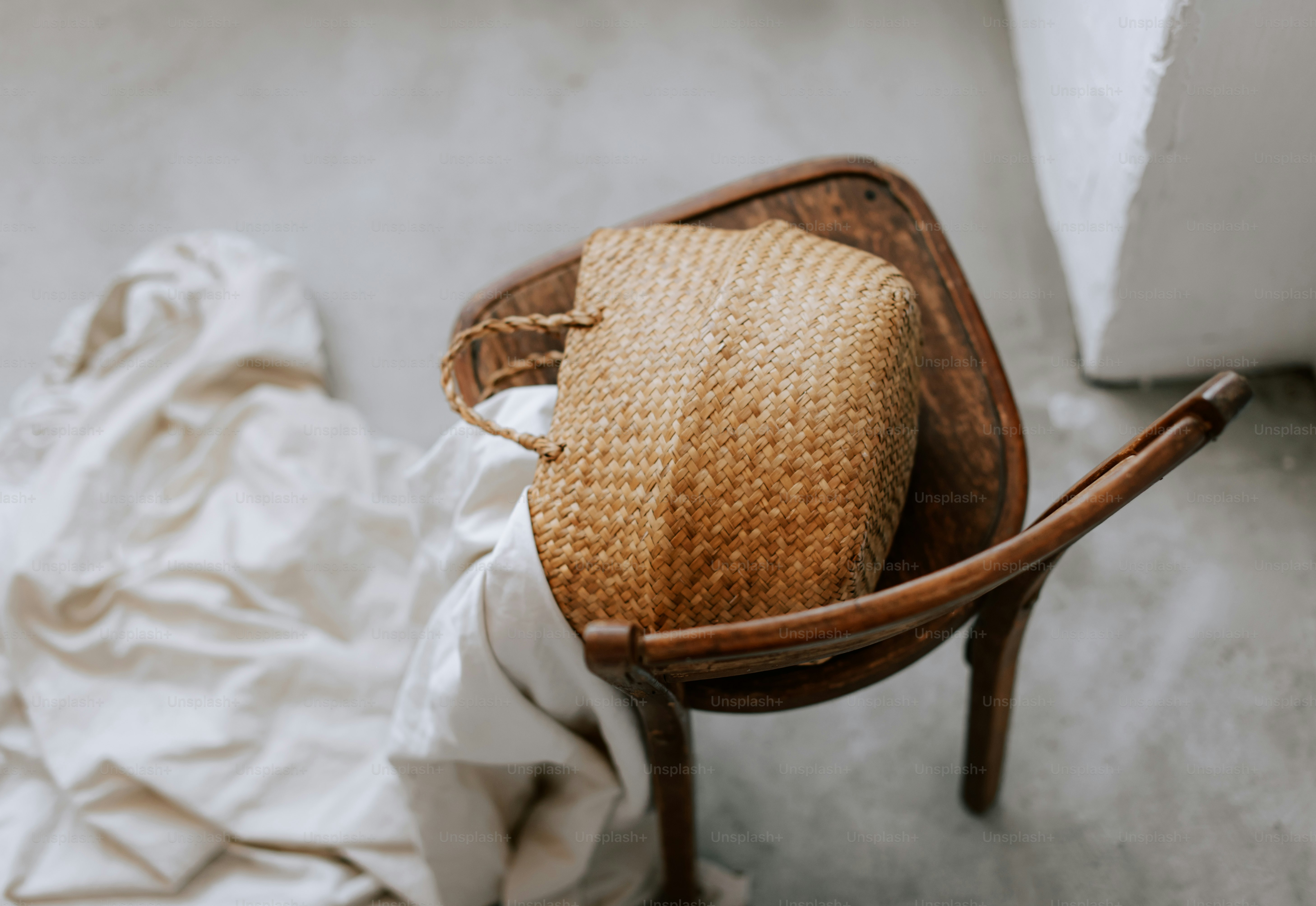 A chair with a straw hat on top of it photo – Neutral aesthetic Image ...