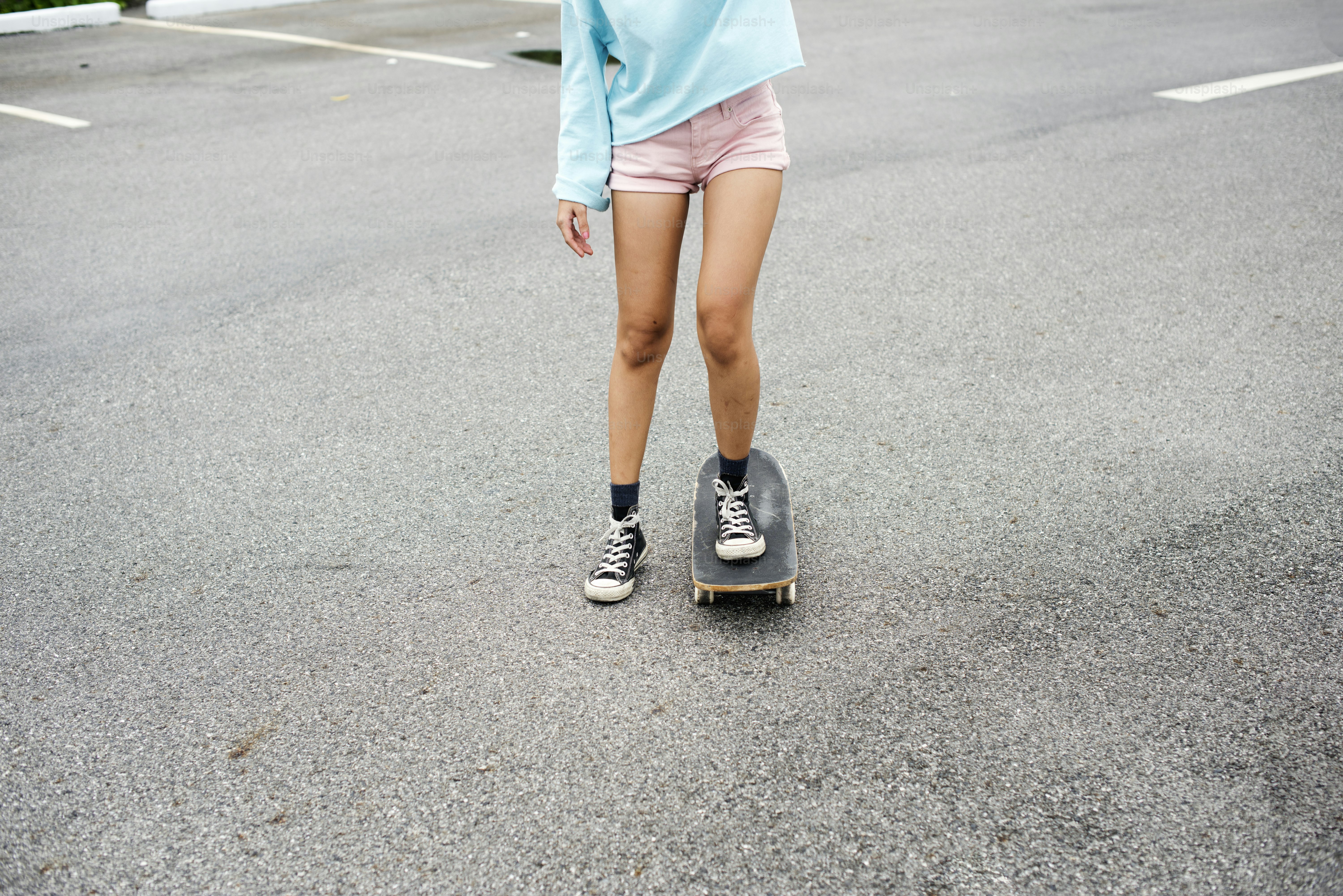 Closeup of woman legs enjoying sketeboard