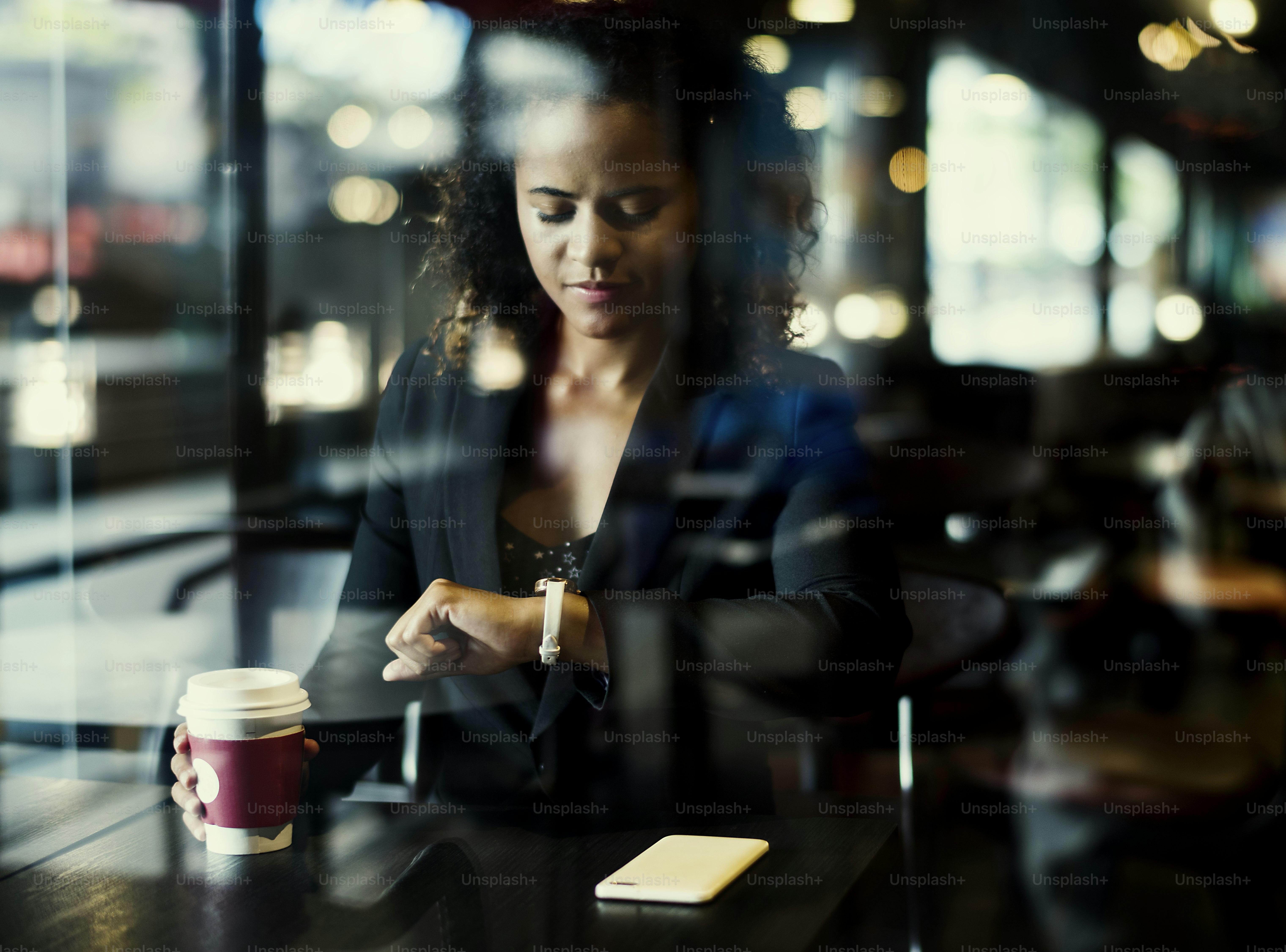 Woman looking at her watch at cafe