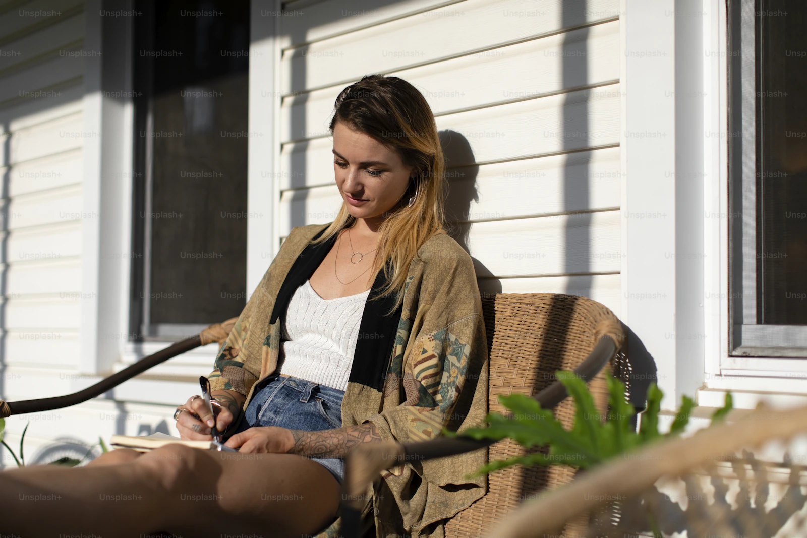 A woman writing at home — the kind of quiet, real workspace where most income-from-home work actually happens.