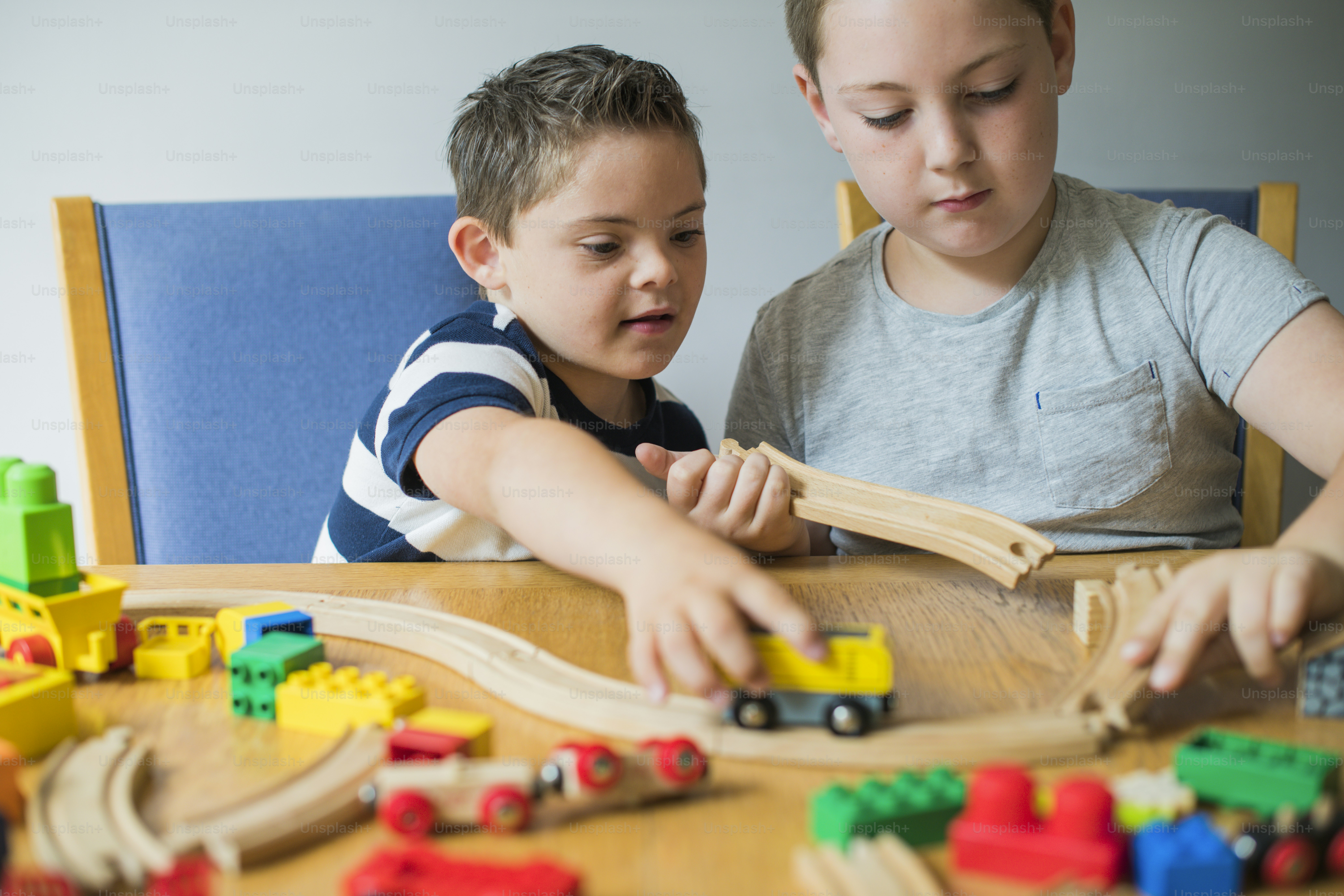 Brothers playing with blocks, trains and cars