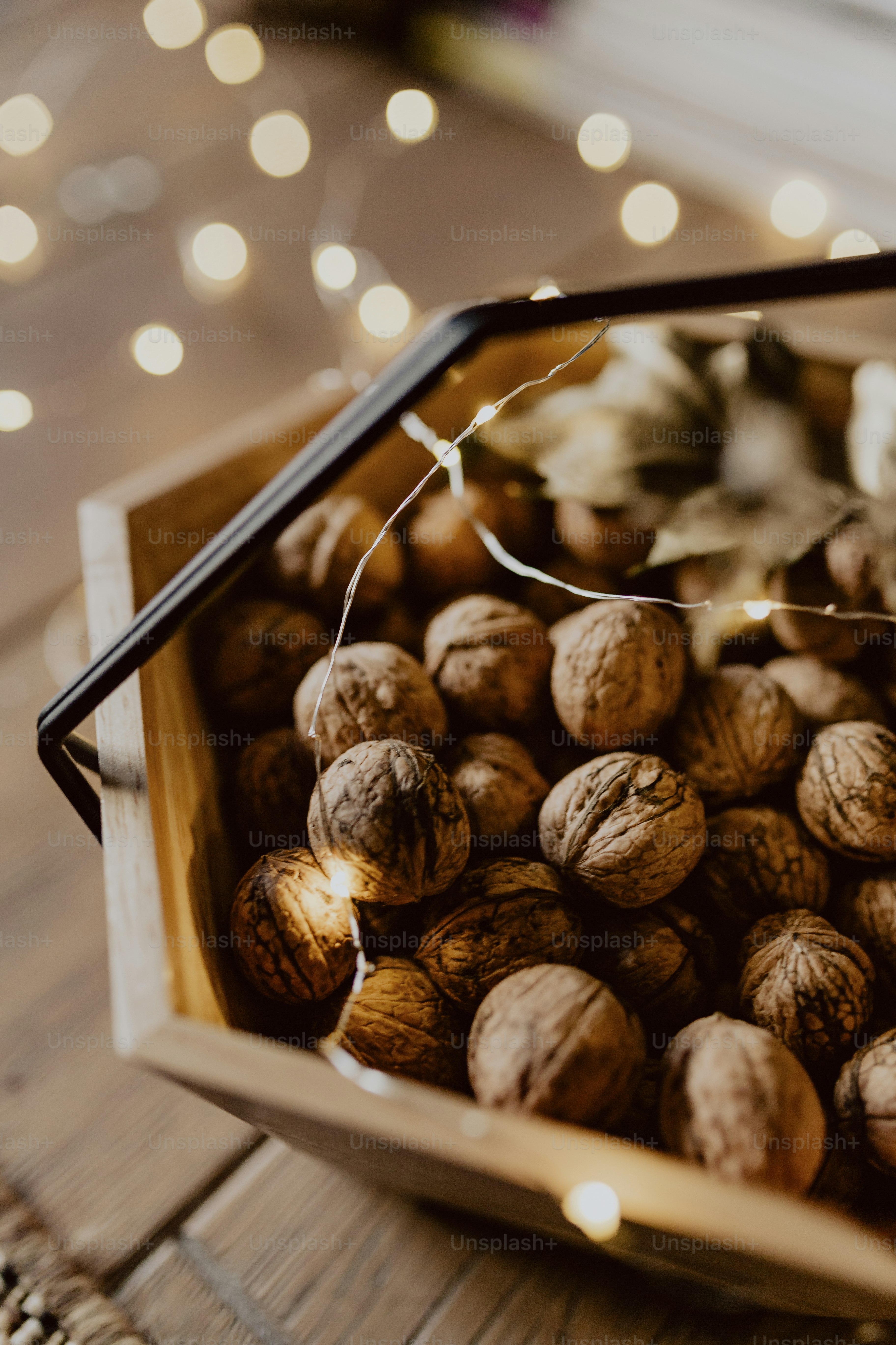 Walnuts in a wooden basket on a wooden floor