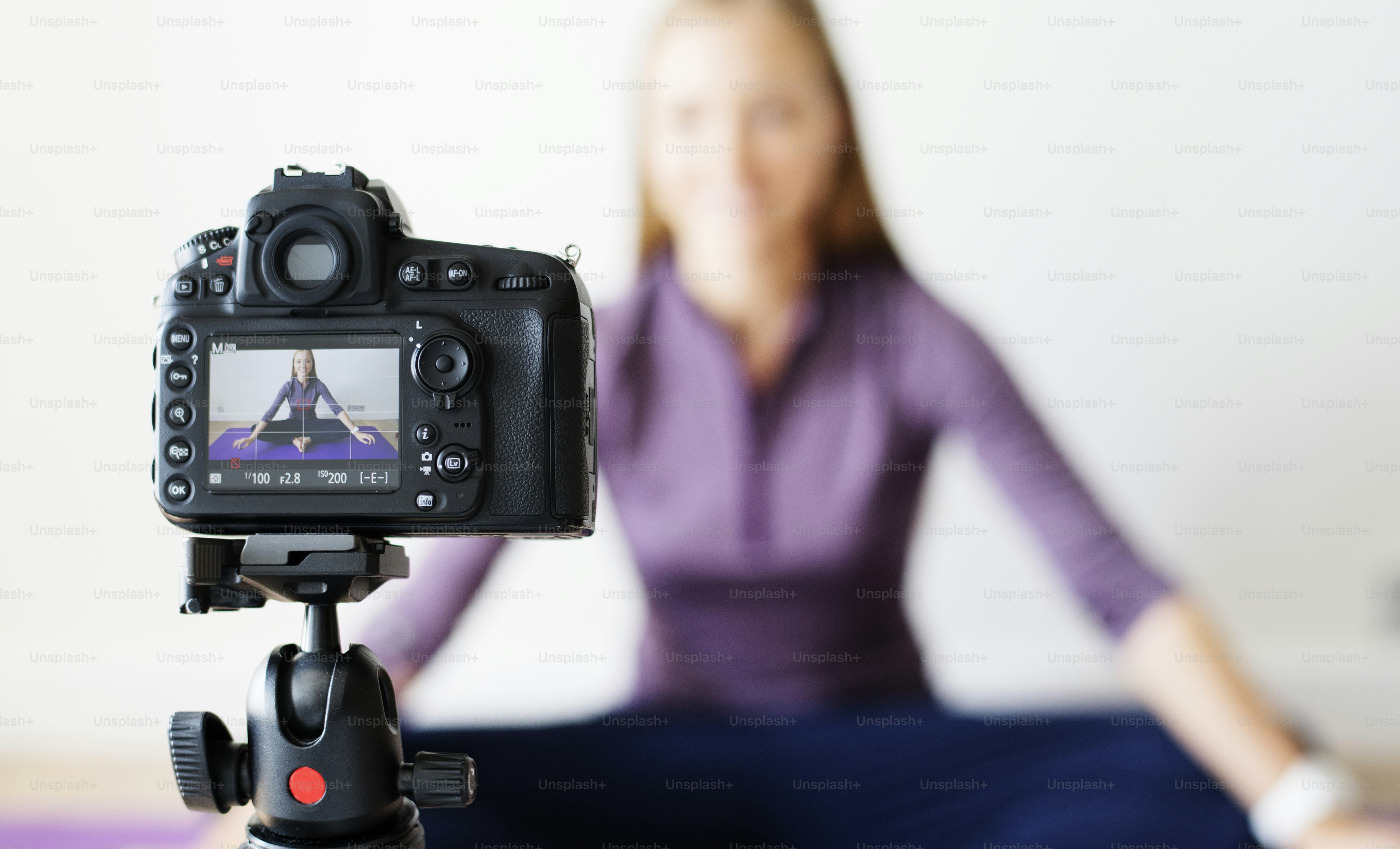 Female vlogger recording sports related broadcast at home