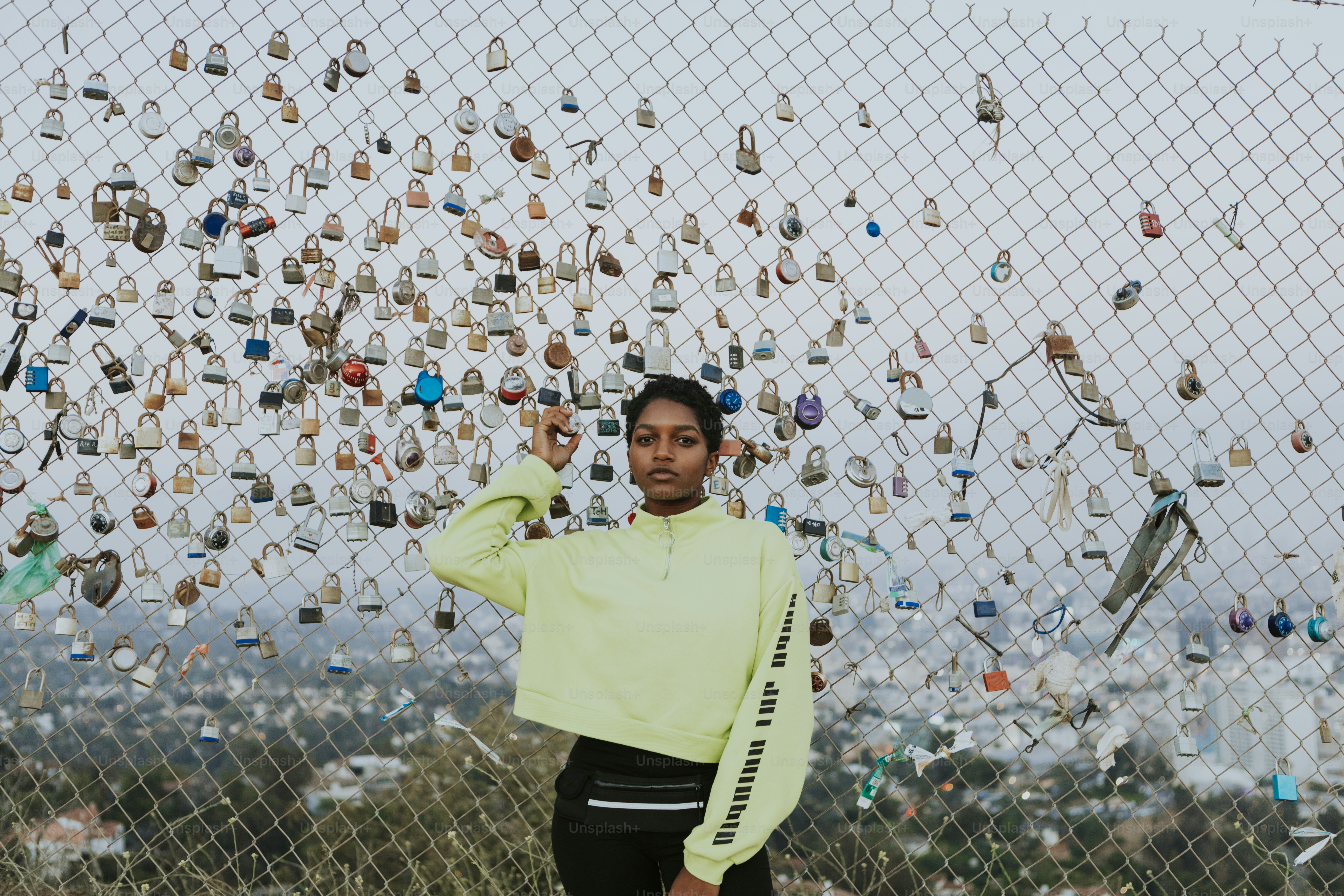 Woman by a fence with padlocks in LA