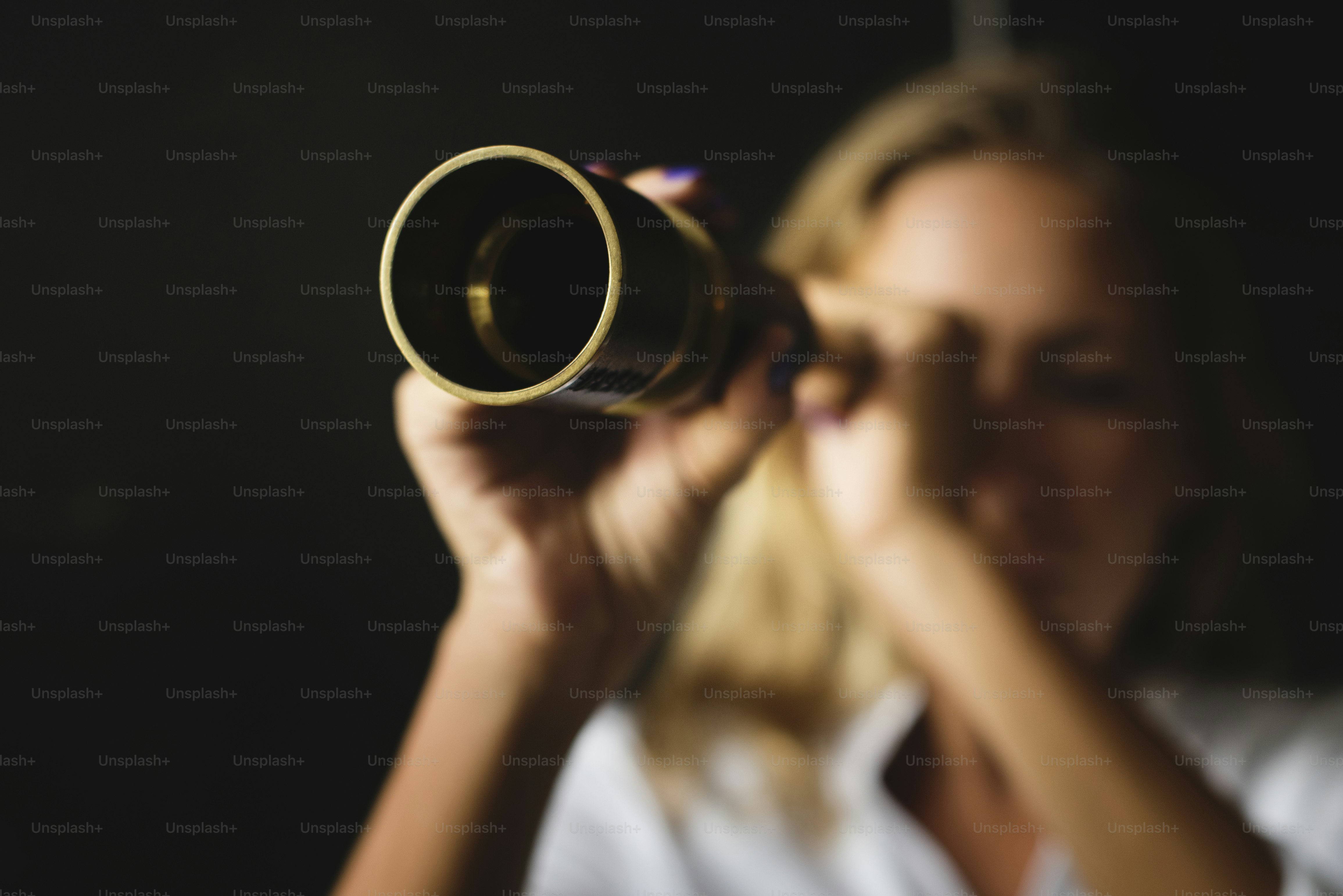 Caucasian woman using telescope spyglass