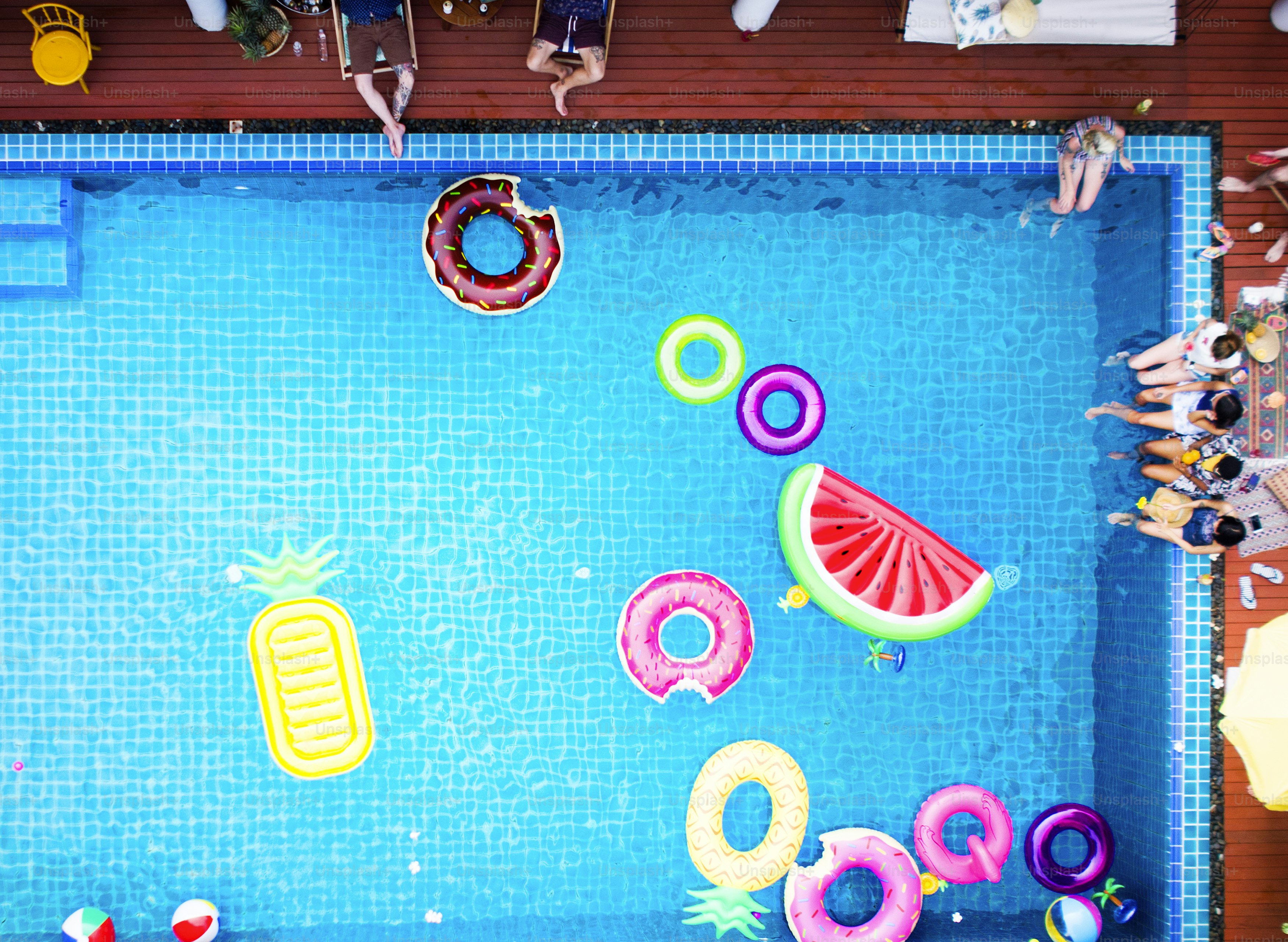 Aerial view of people enjoying the pool with inflatable tubes