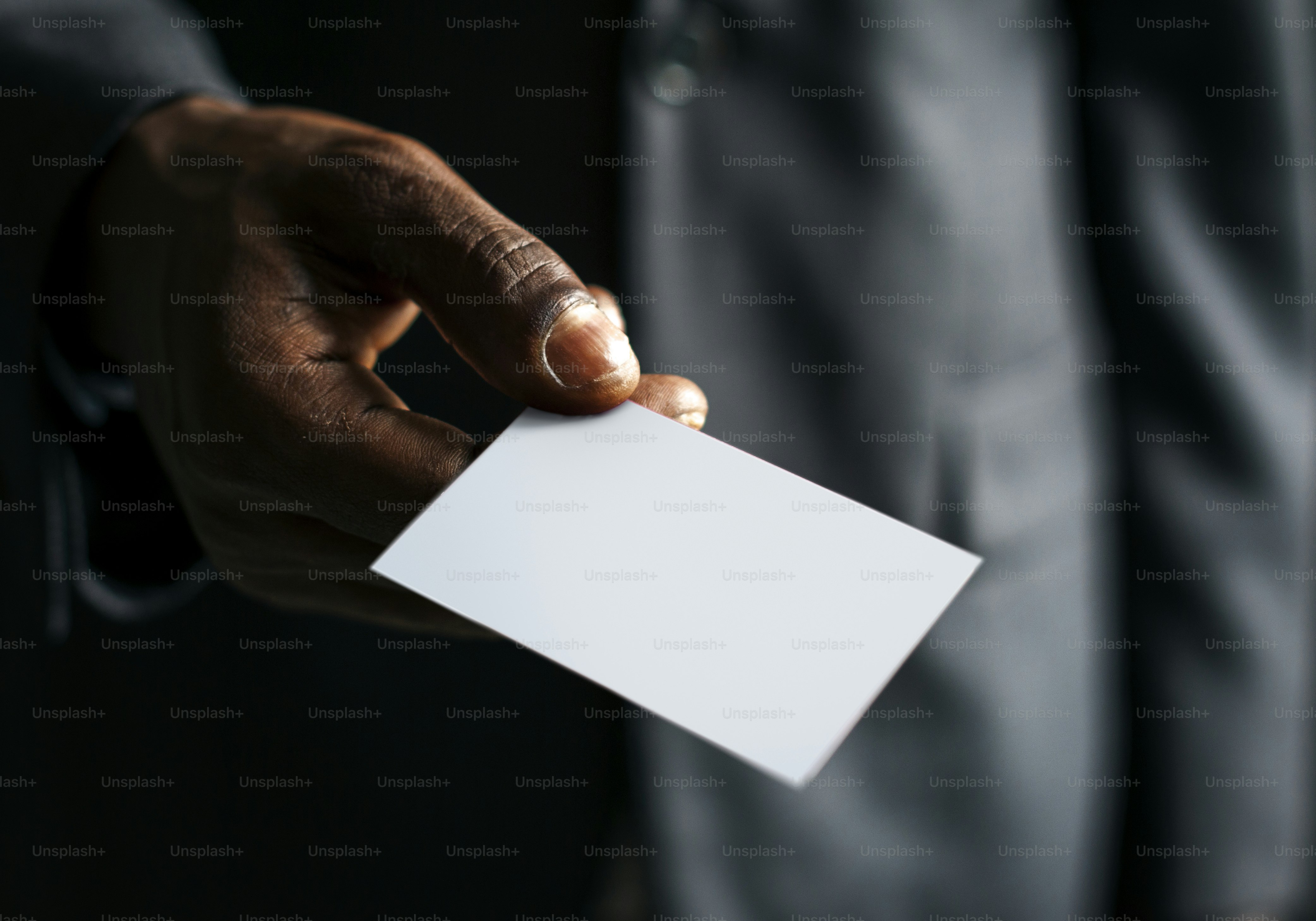 Closeup of hand holding blank white paper card