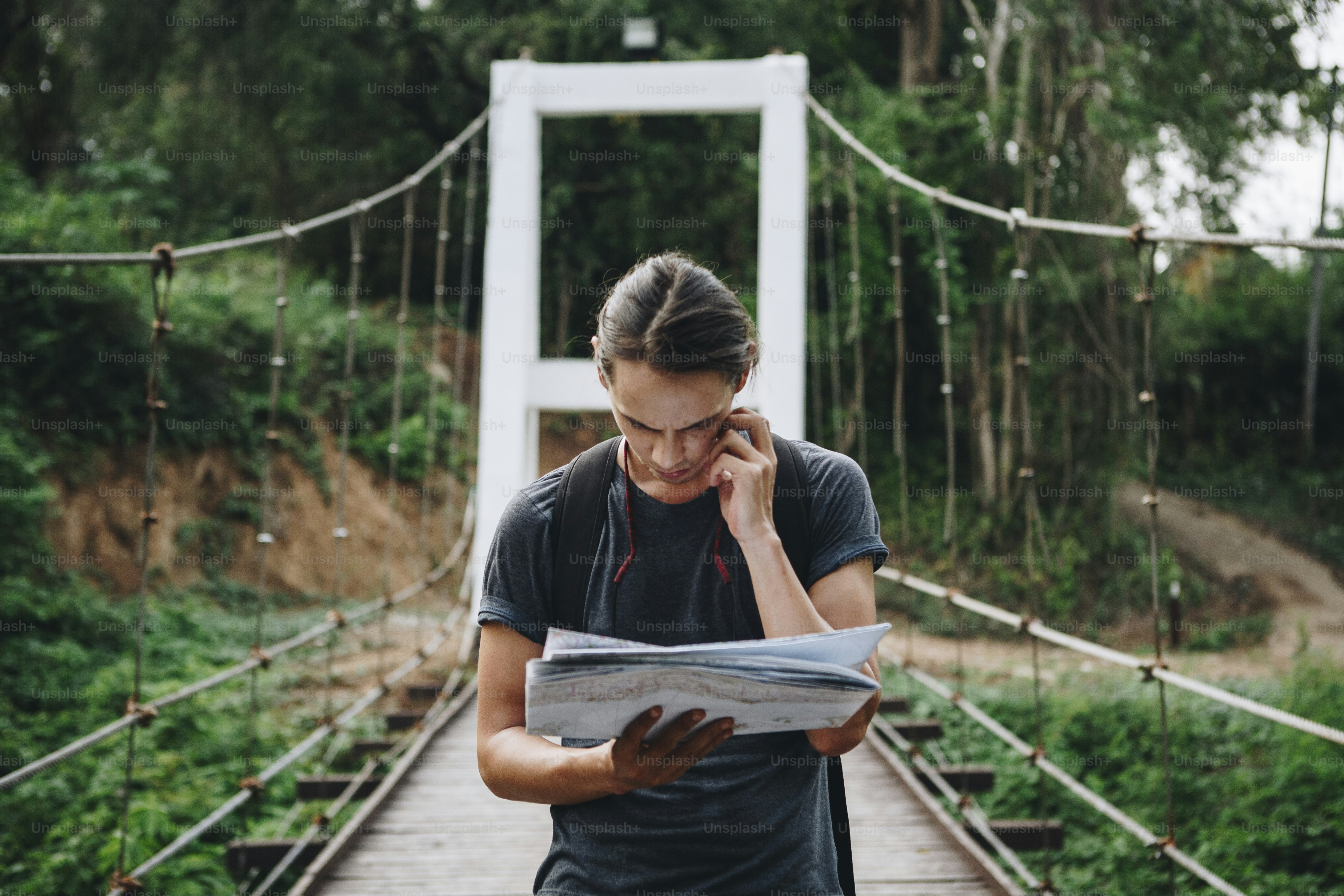 Confused Caucasian man looking at a map travel and explore concept
