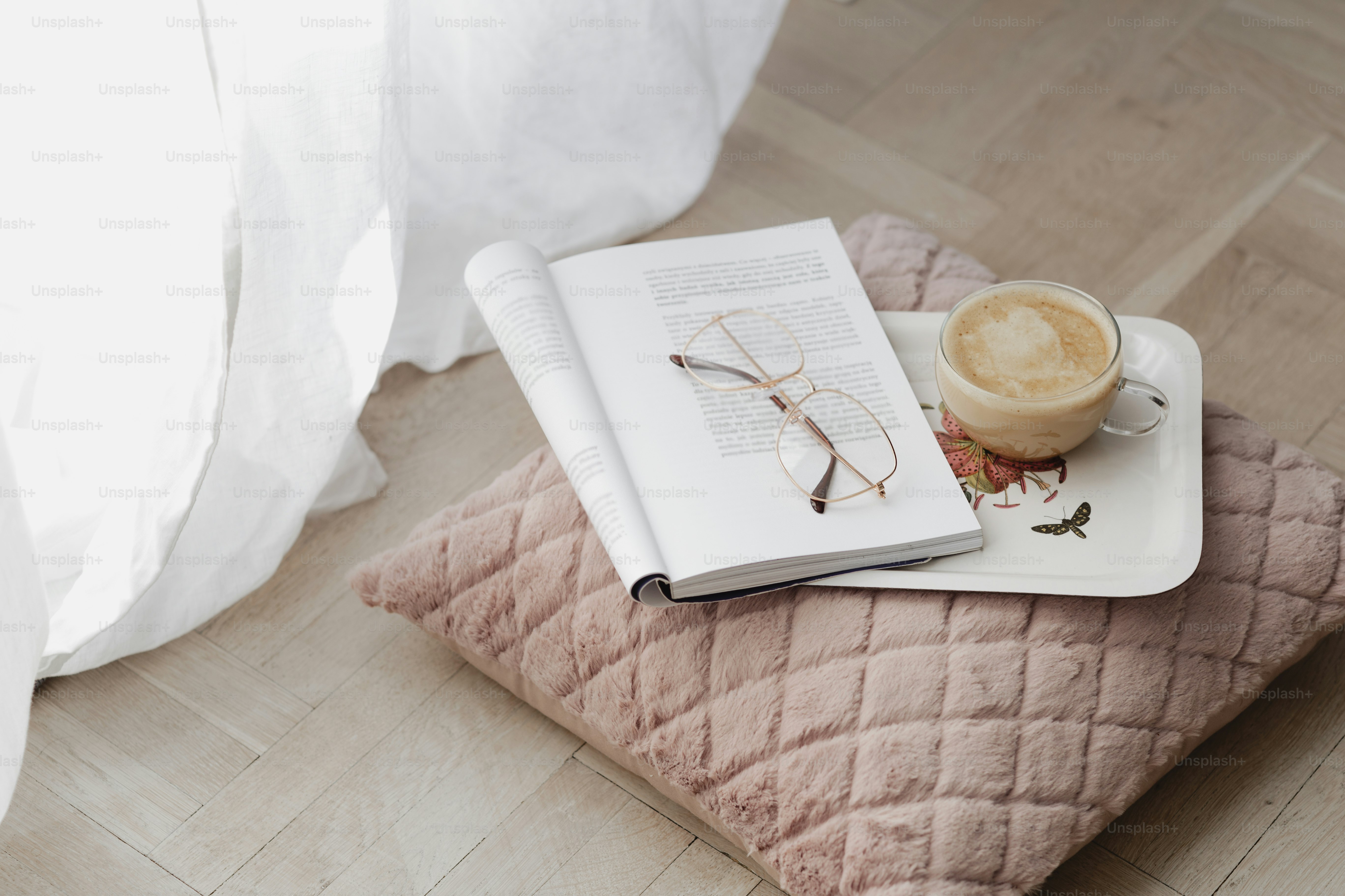 Coffee on a pink velvet cushion with an opened magazine</p>

<p style=