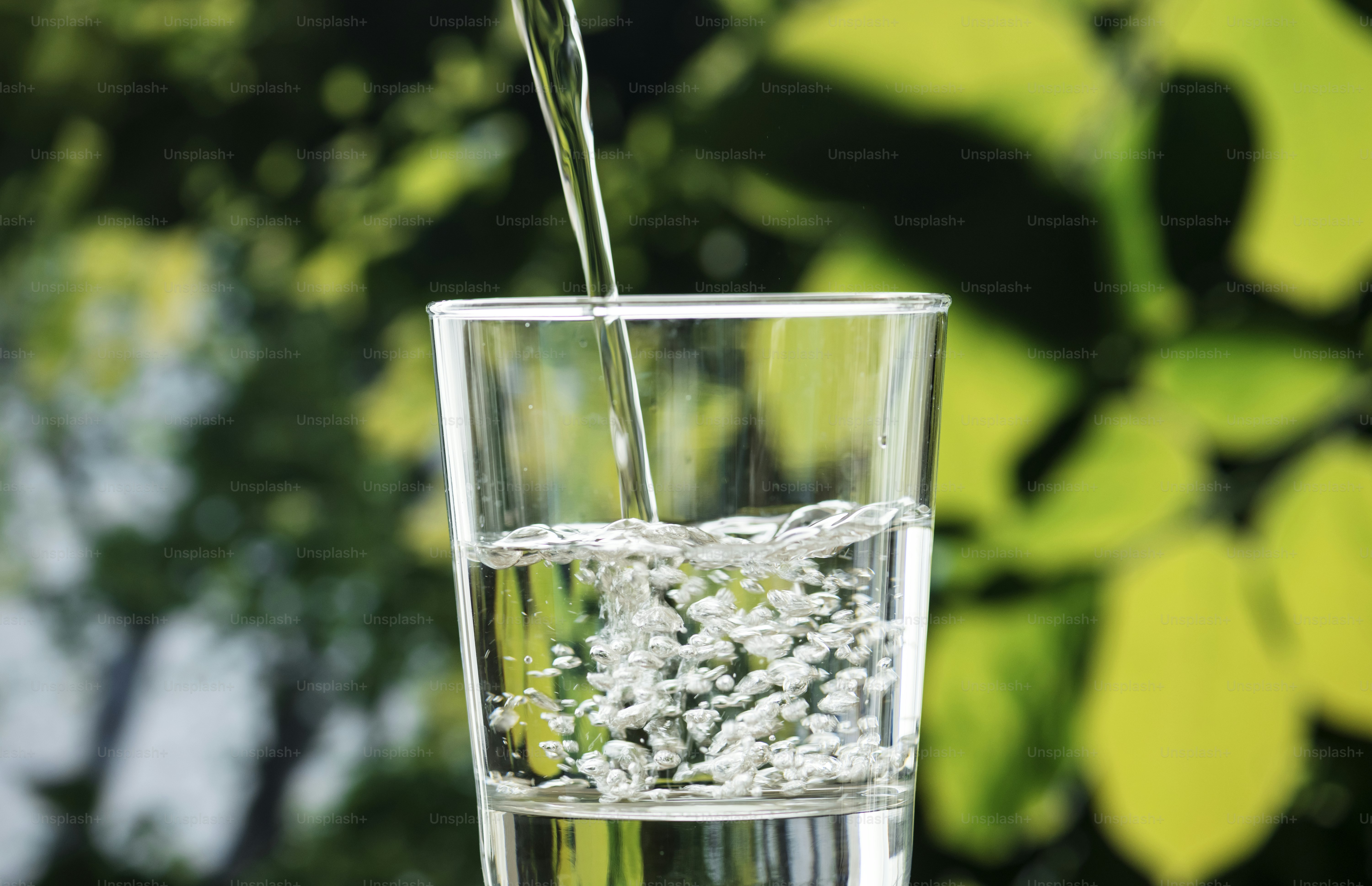 Macro shot of pouring water into a glass