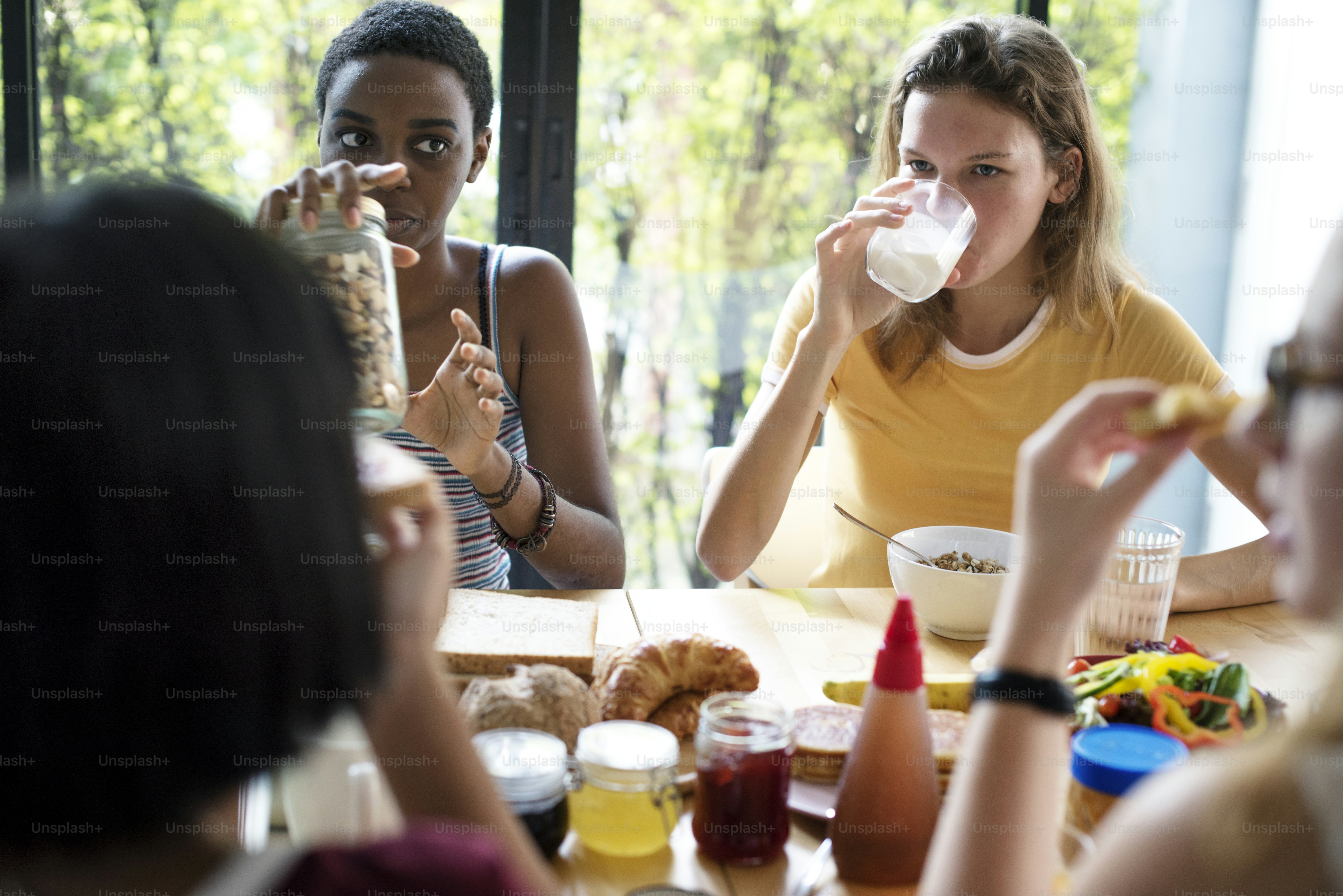 Group of girlfriends having breakfast together