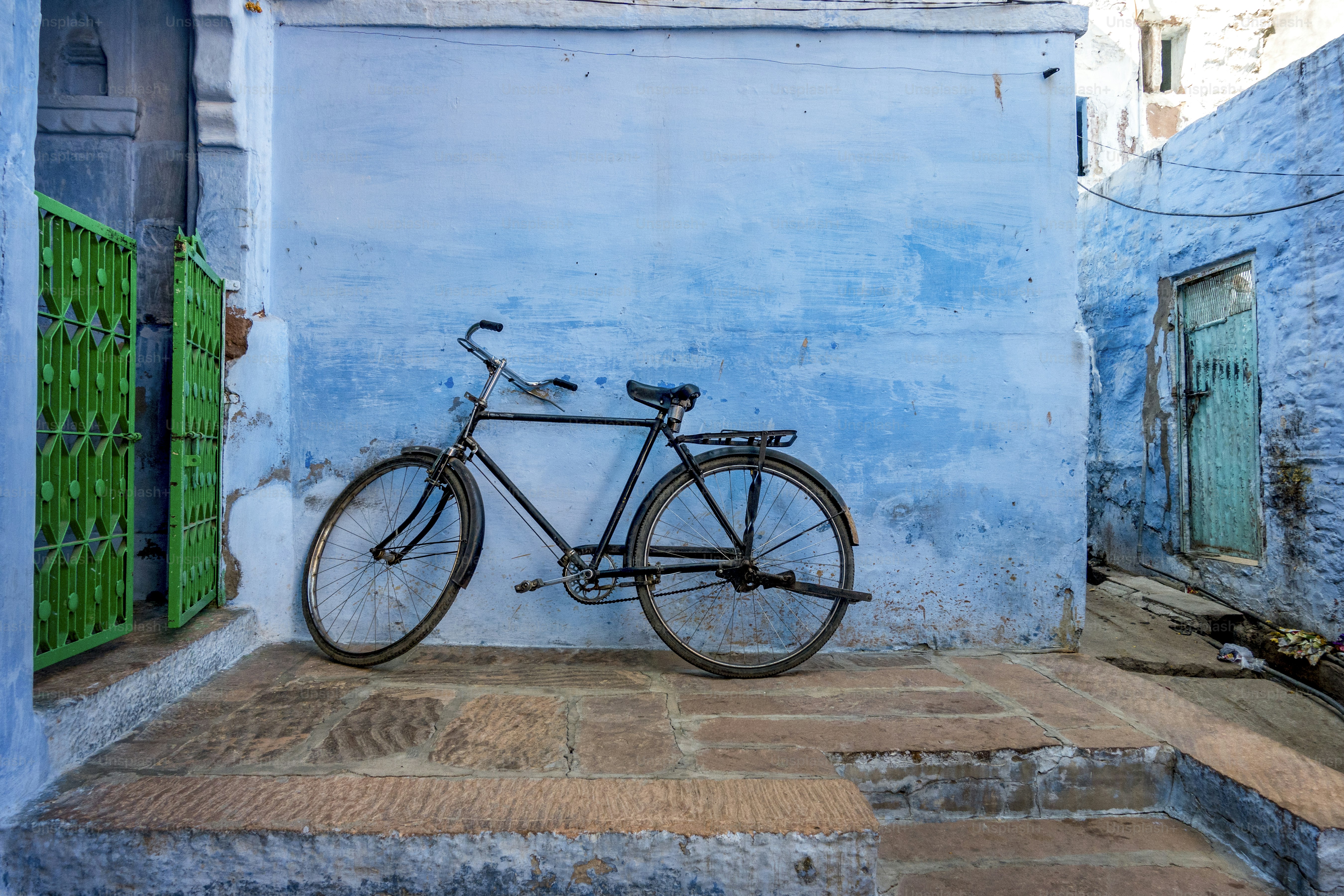 Bicycle leaning on the blue wall