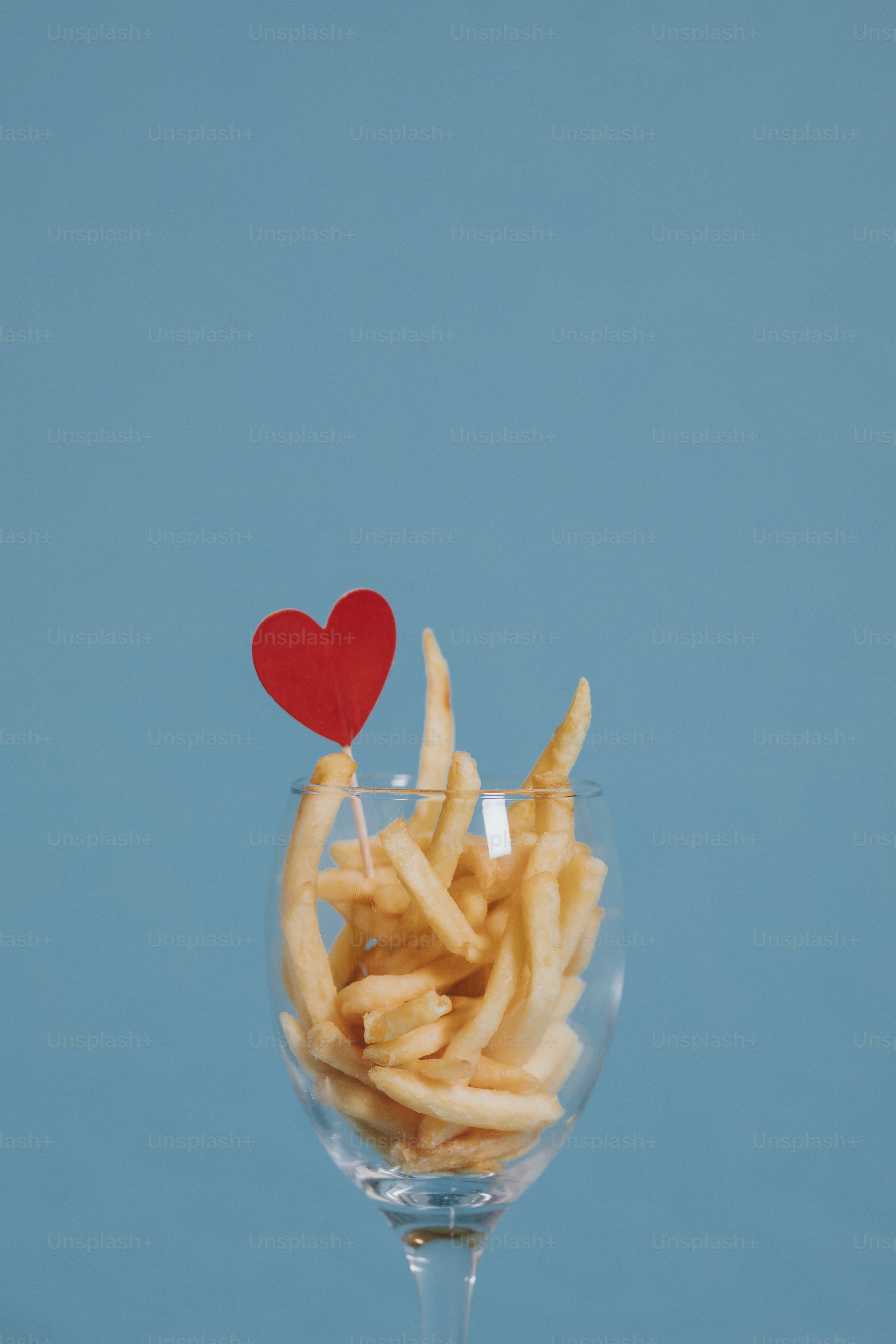 French fries in a wine glass with a heart ornament