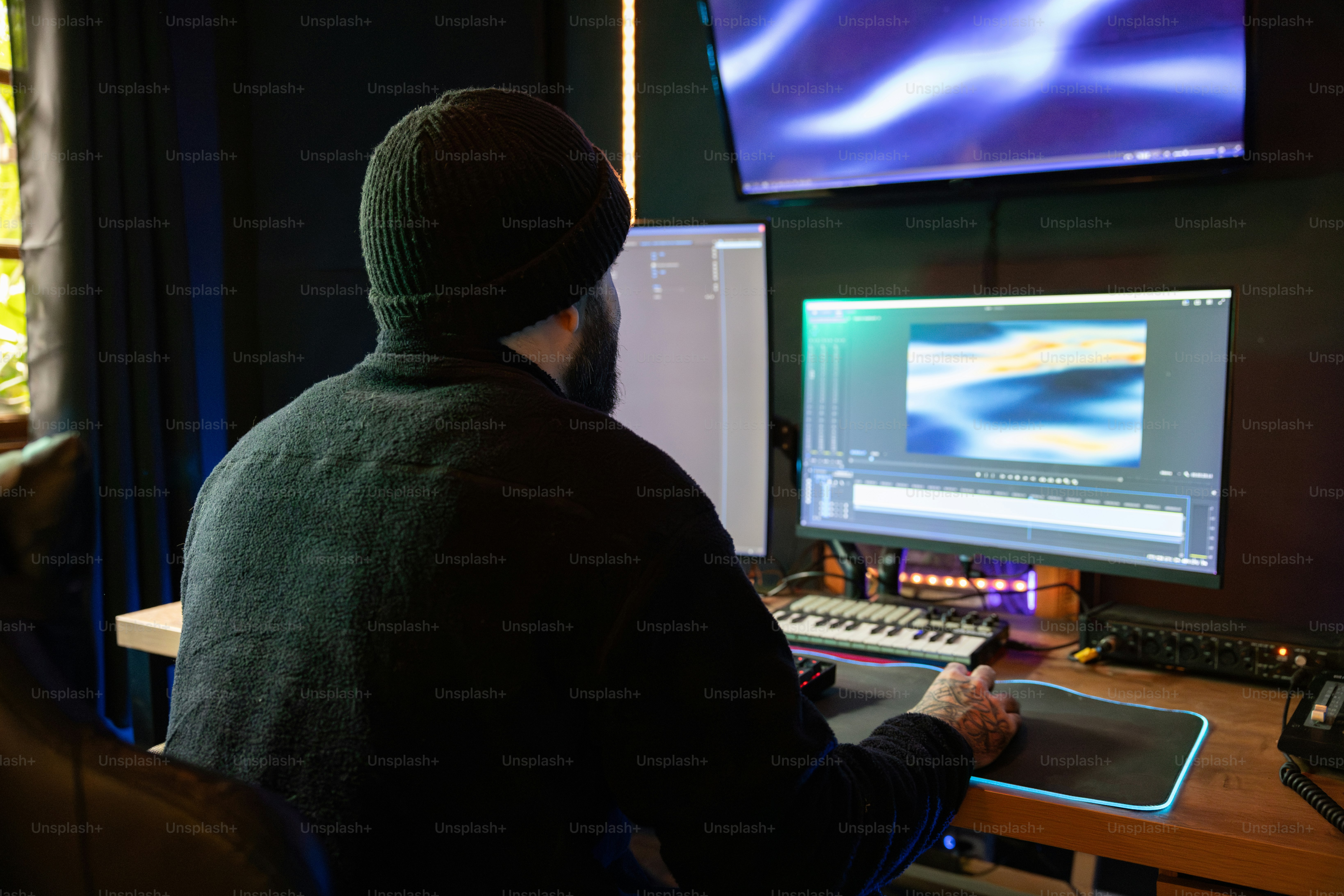 A man sitting at a desk in front of a computer