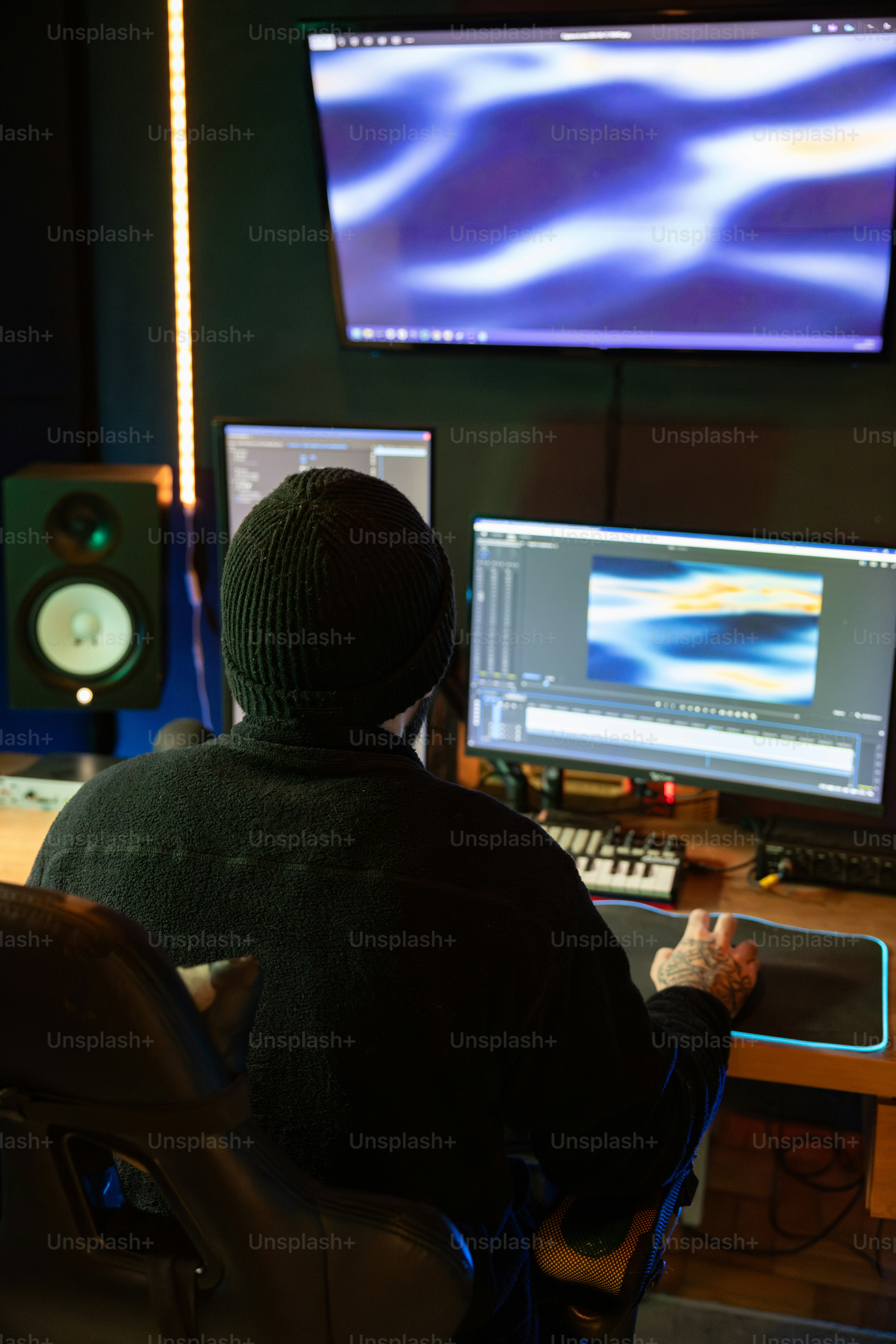 A person sitting in front of a computer monitor photo – Video editor ...