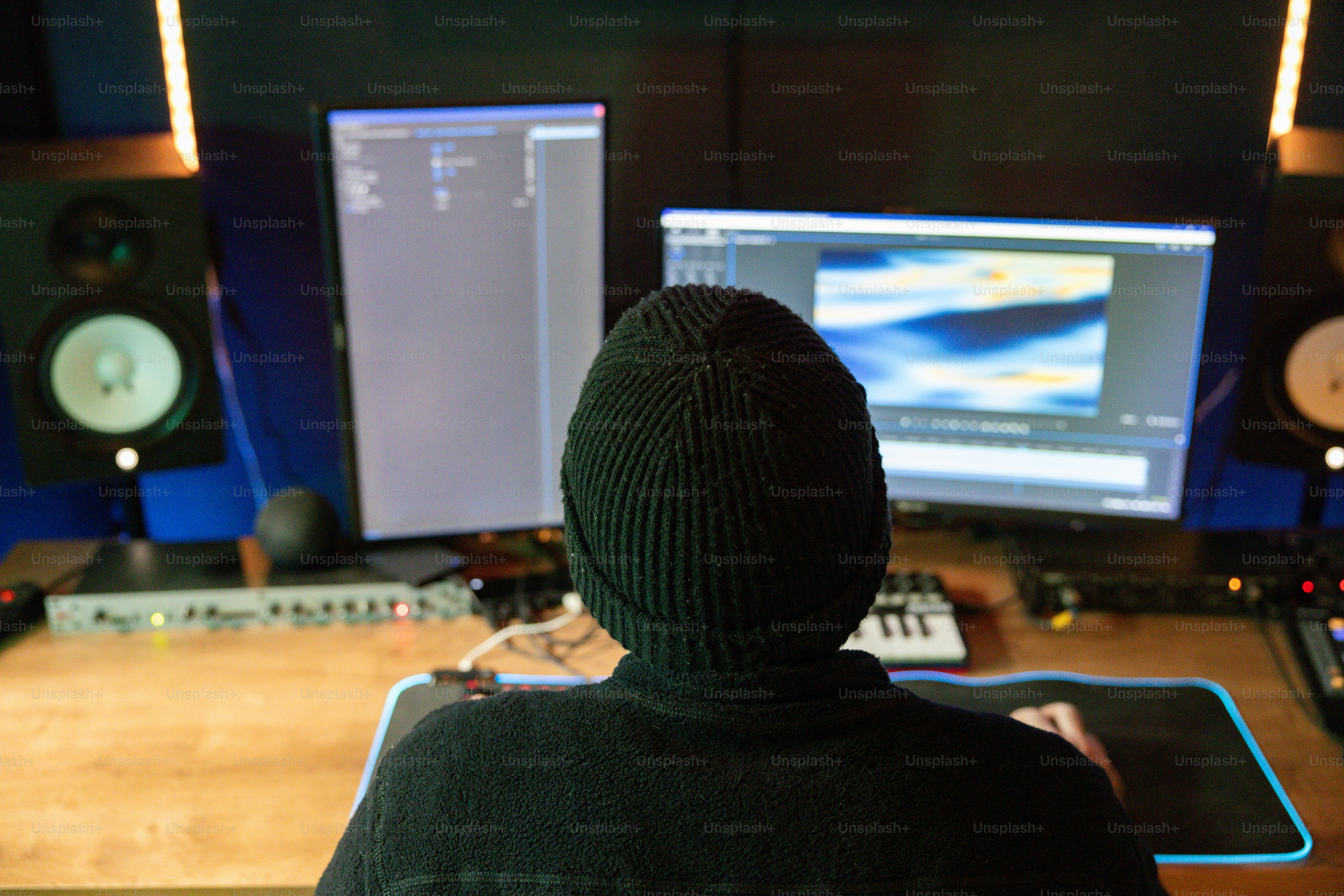A person sitting at a desk in front of a computer photo – Video editing ...