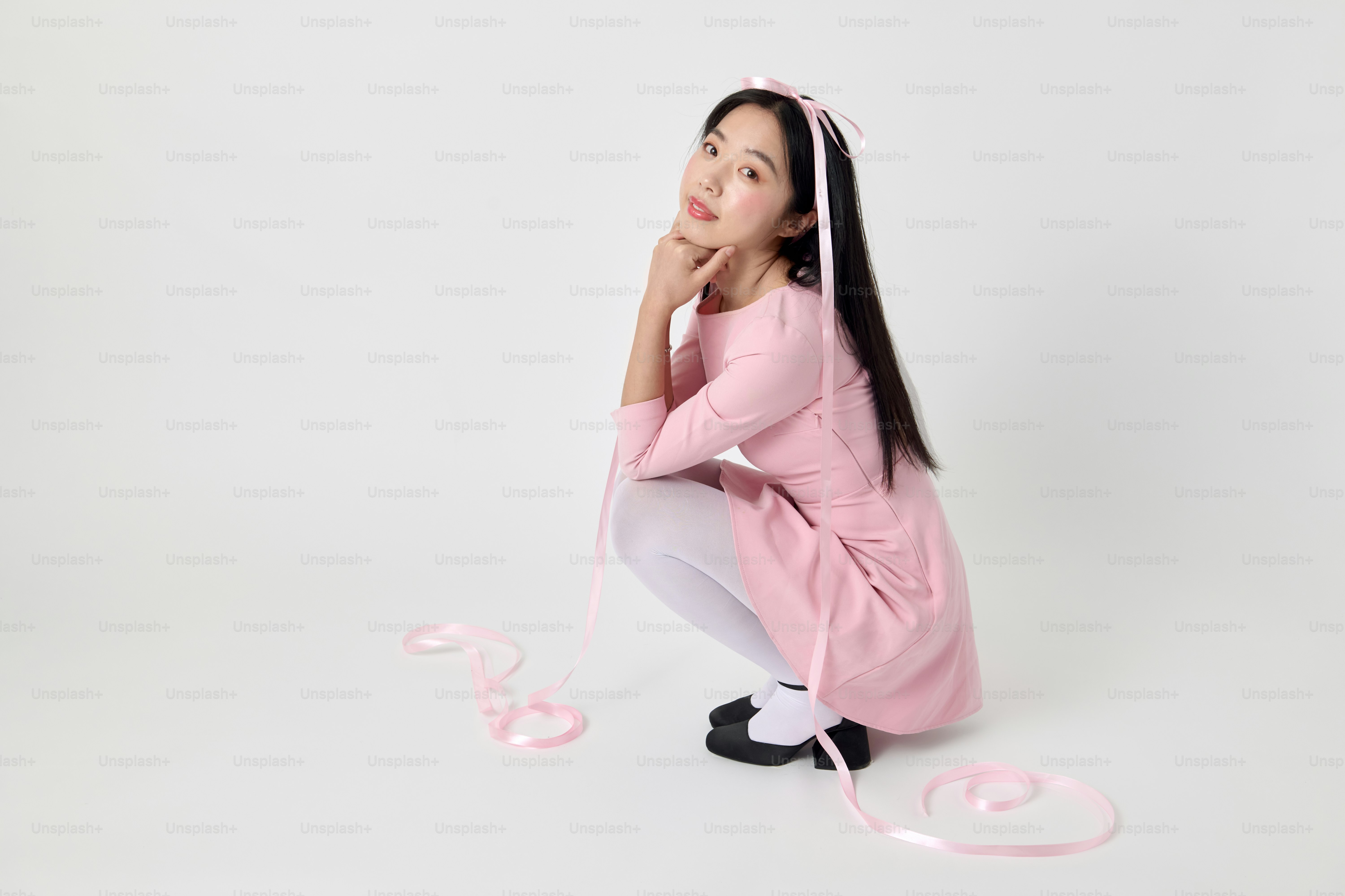 A woman in a pink shirt and white pants