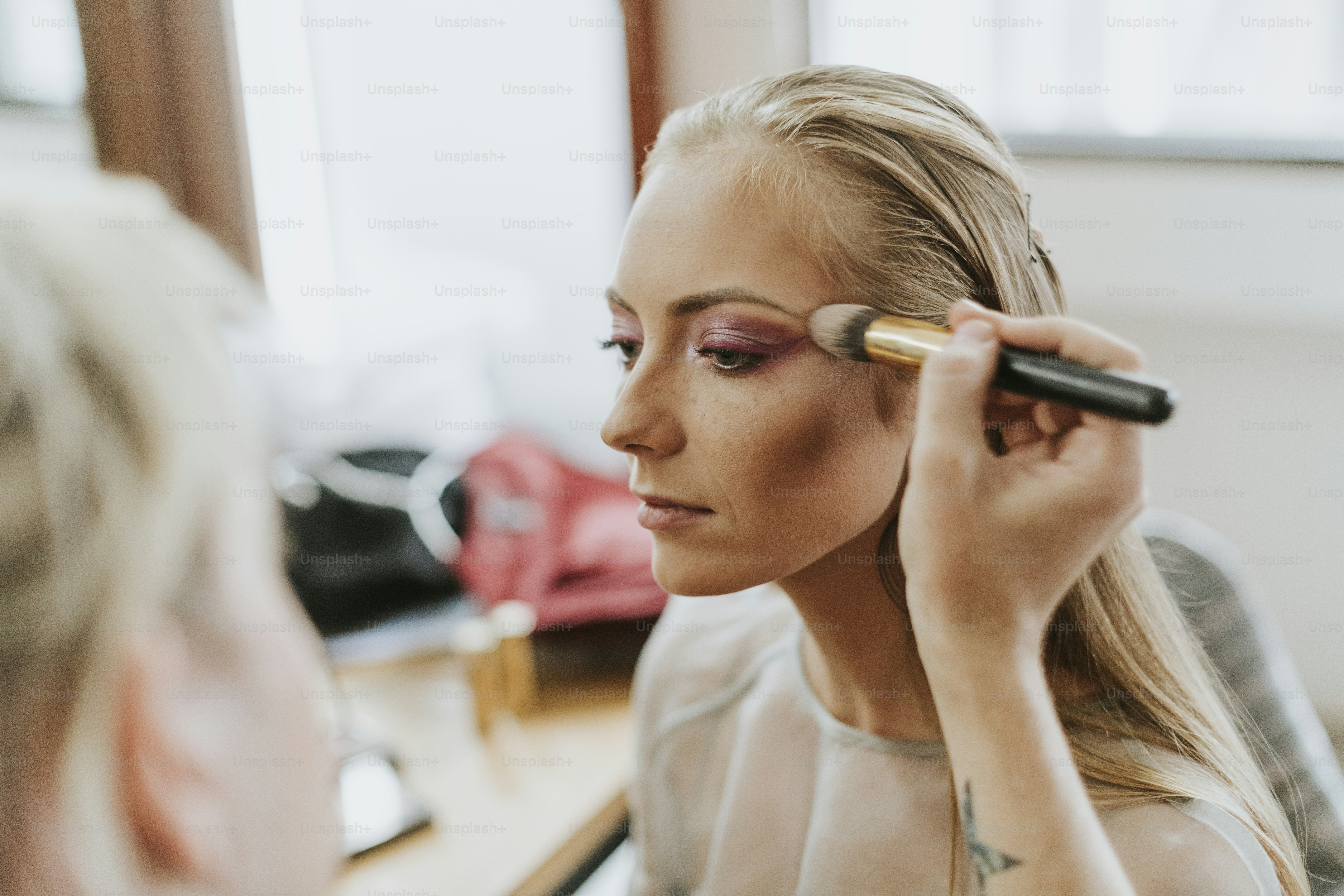 Model getting her makeup done