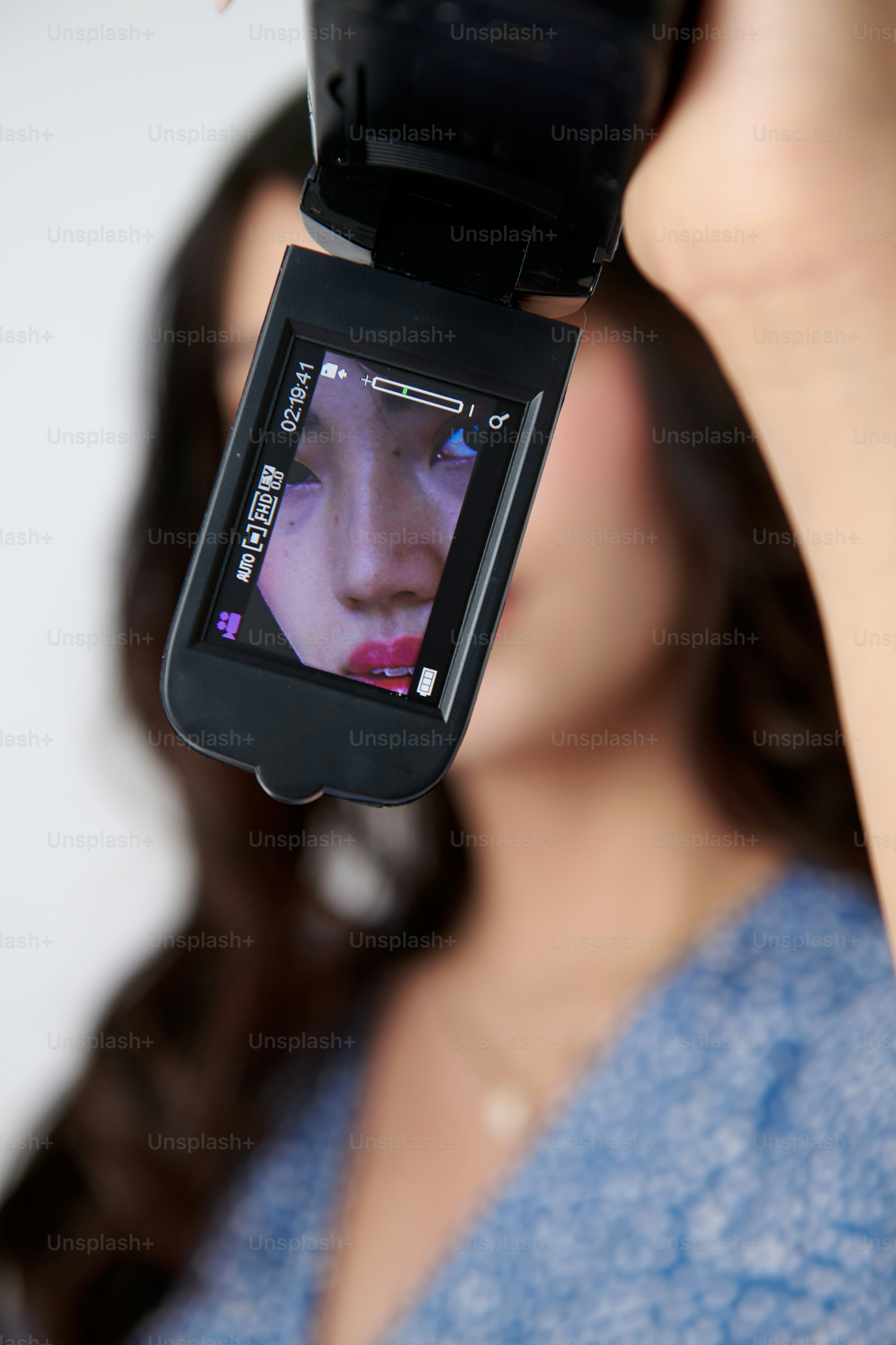 A woman holding a cell phone up to her face