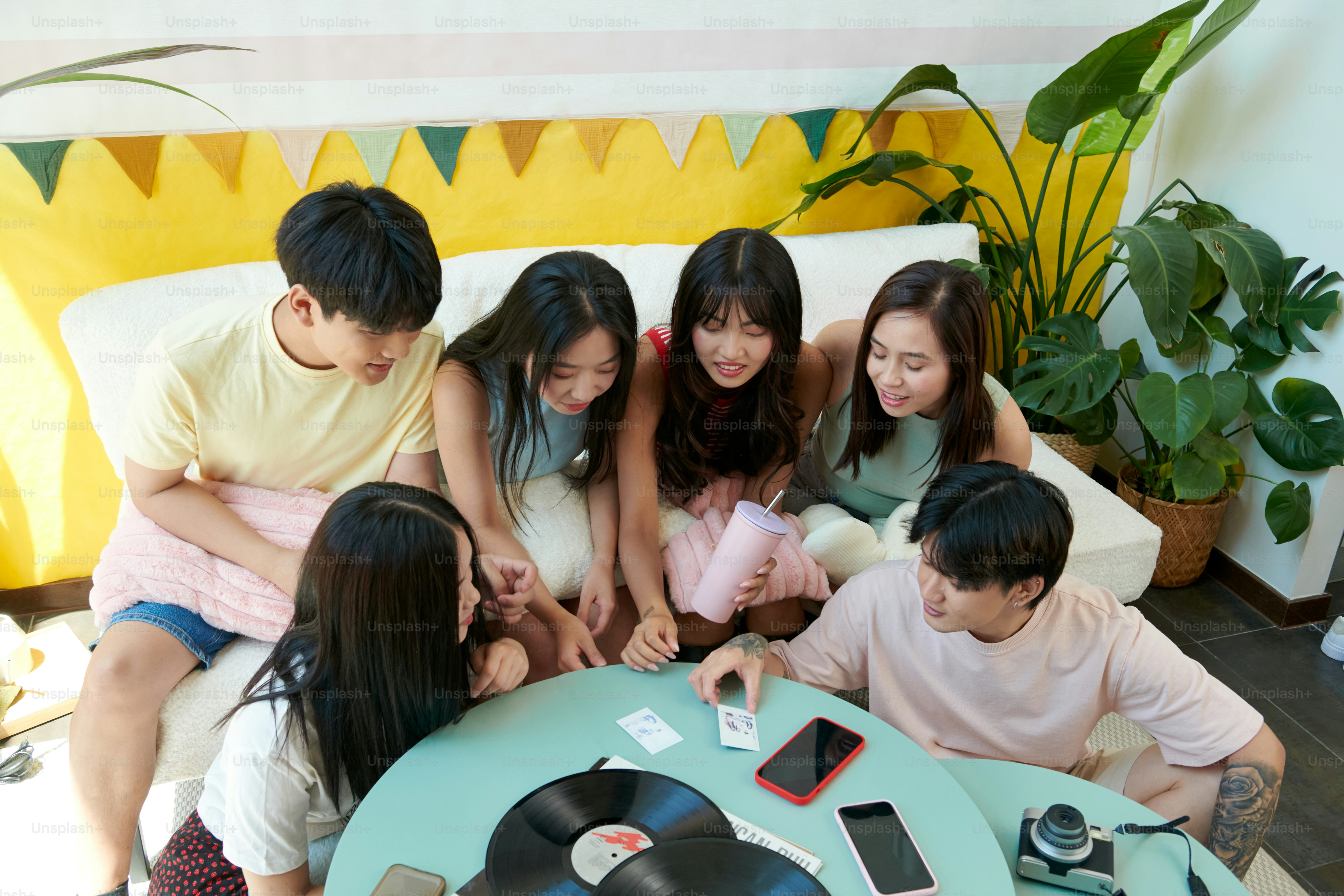 A group of people sitting around a record player