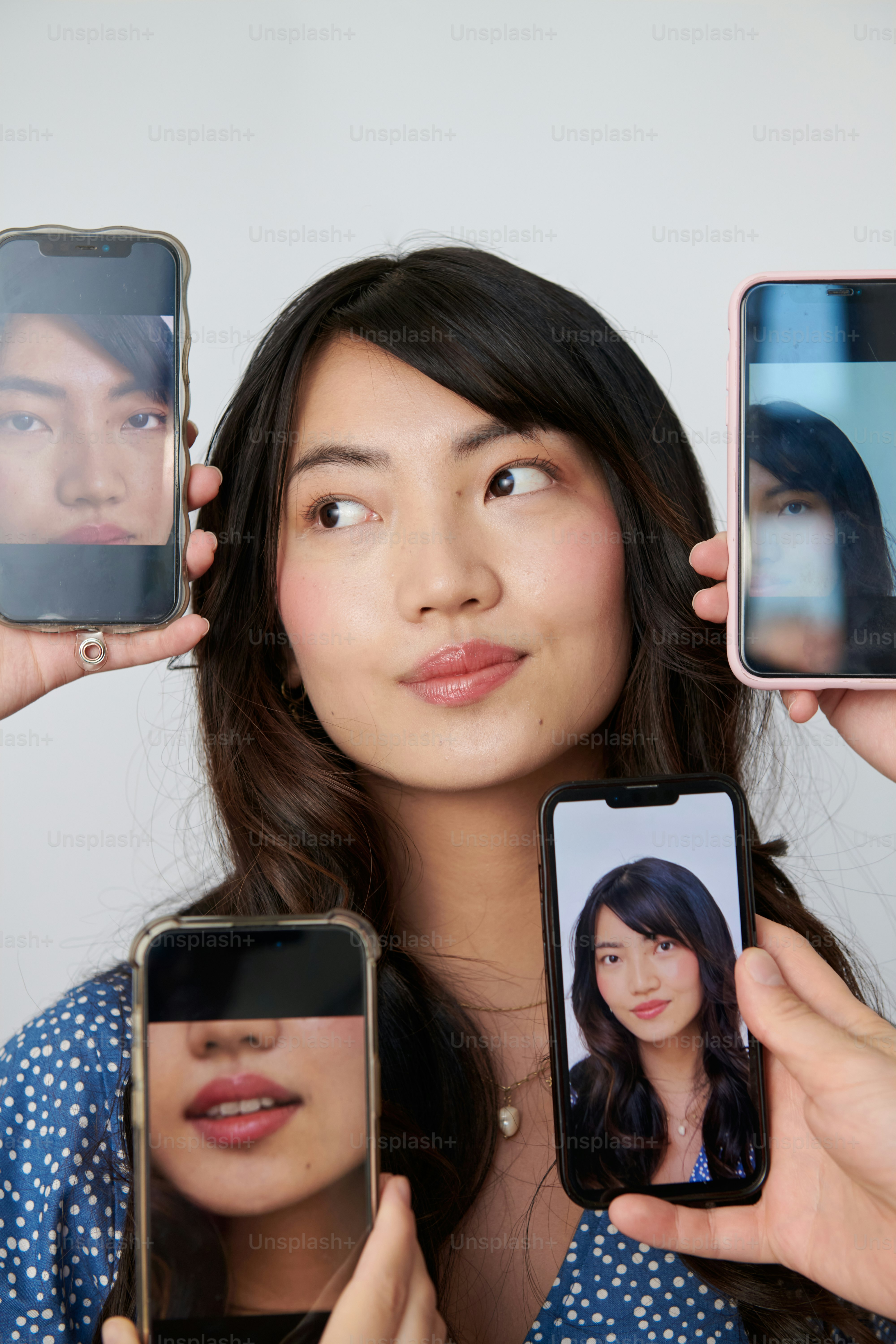A group of people holding up cell phones