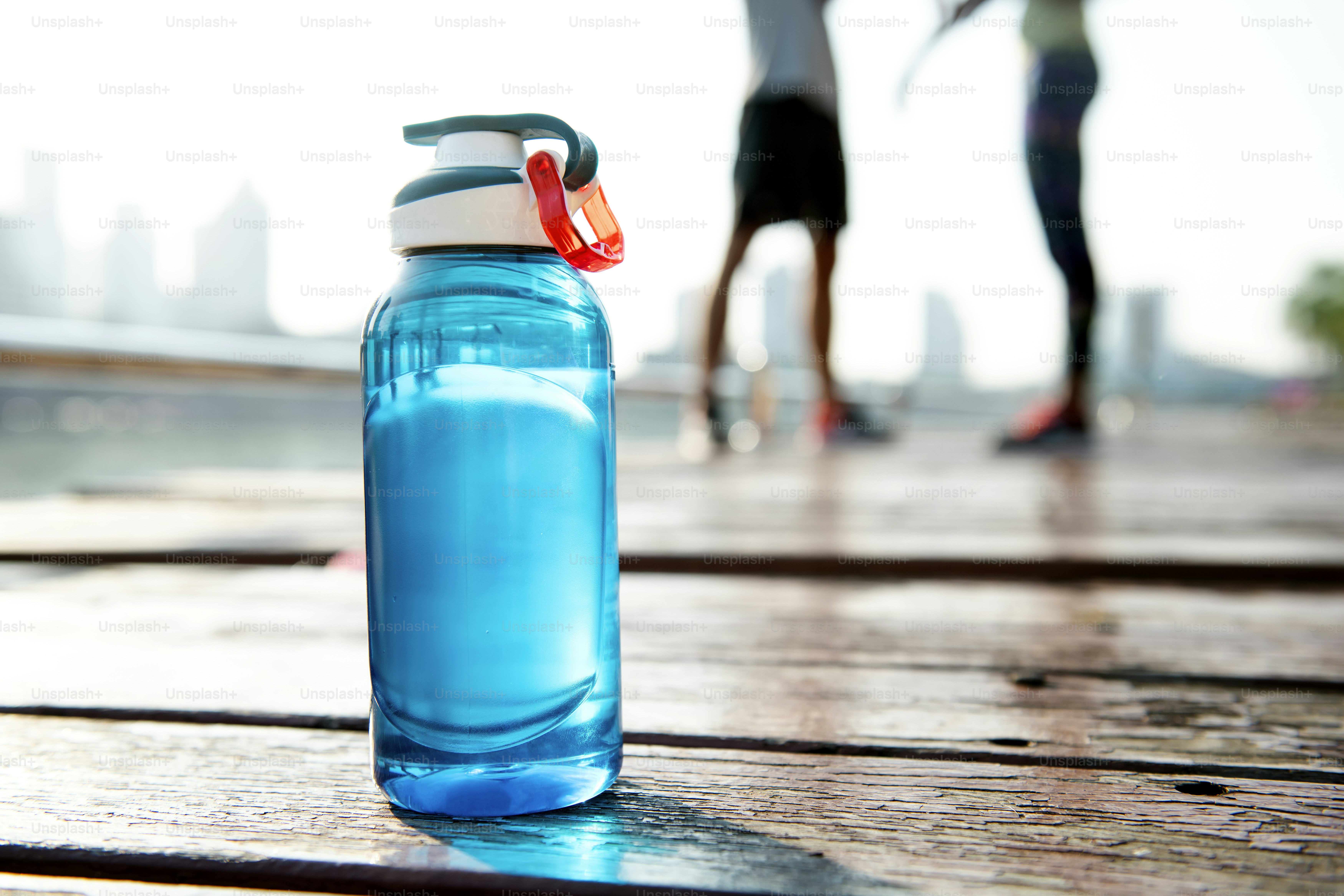 Traveler practicing low waste travel by refilling a reusable water bottle
