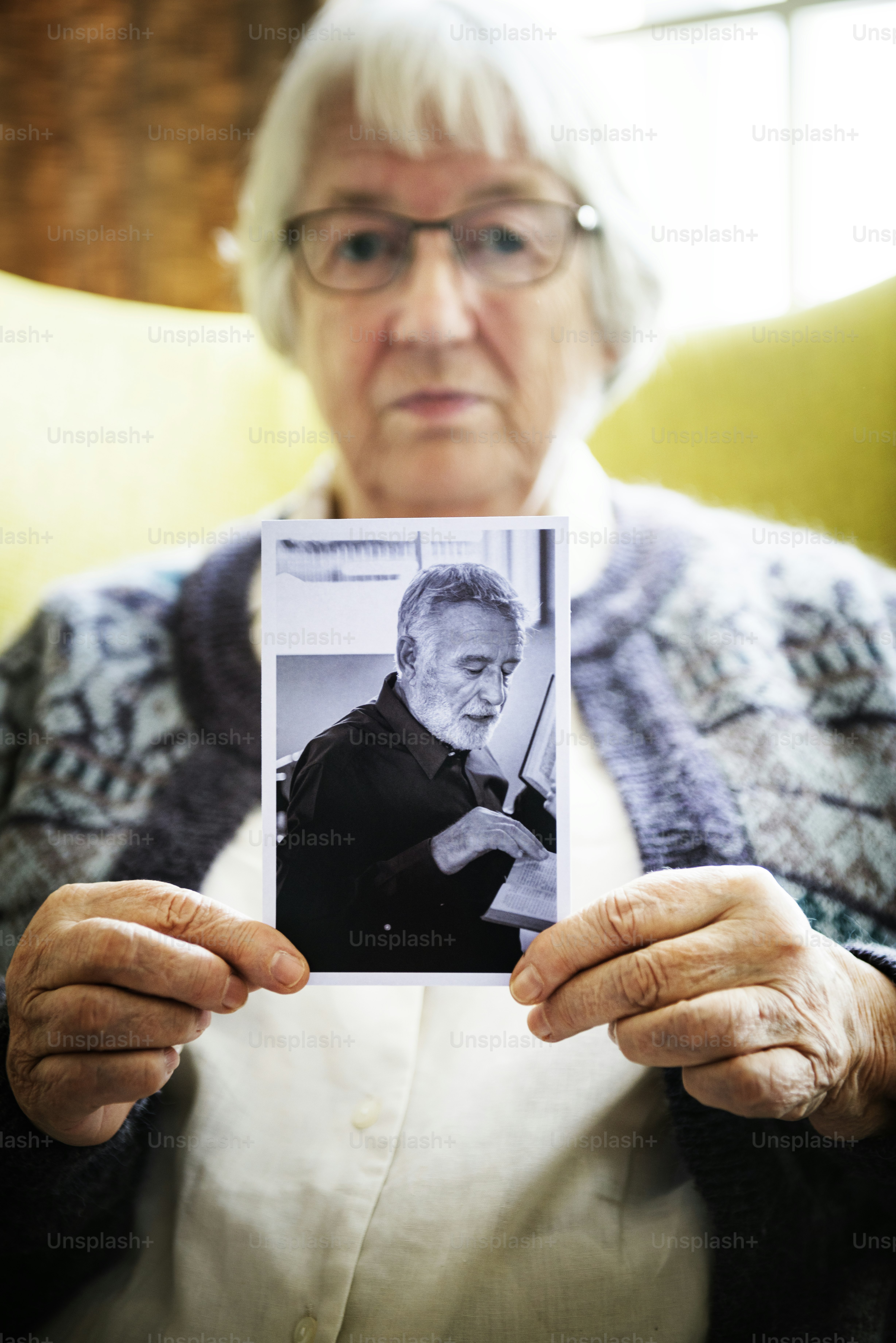 Femme âgée tenant une photo d’un homme âgé