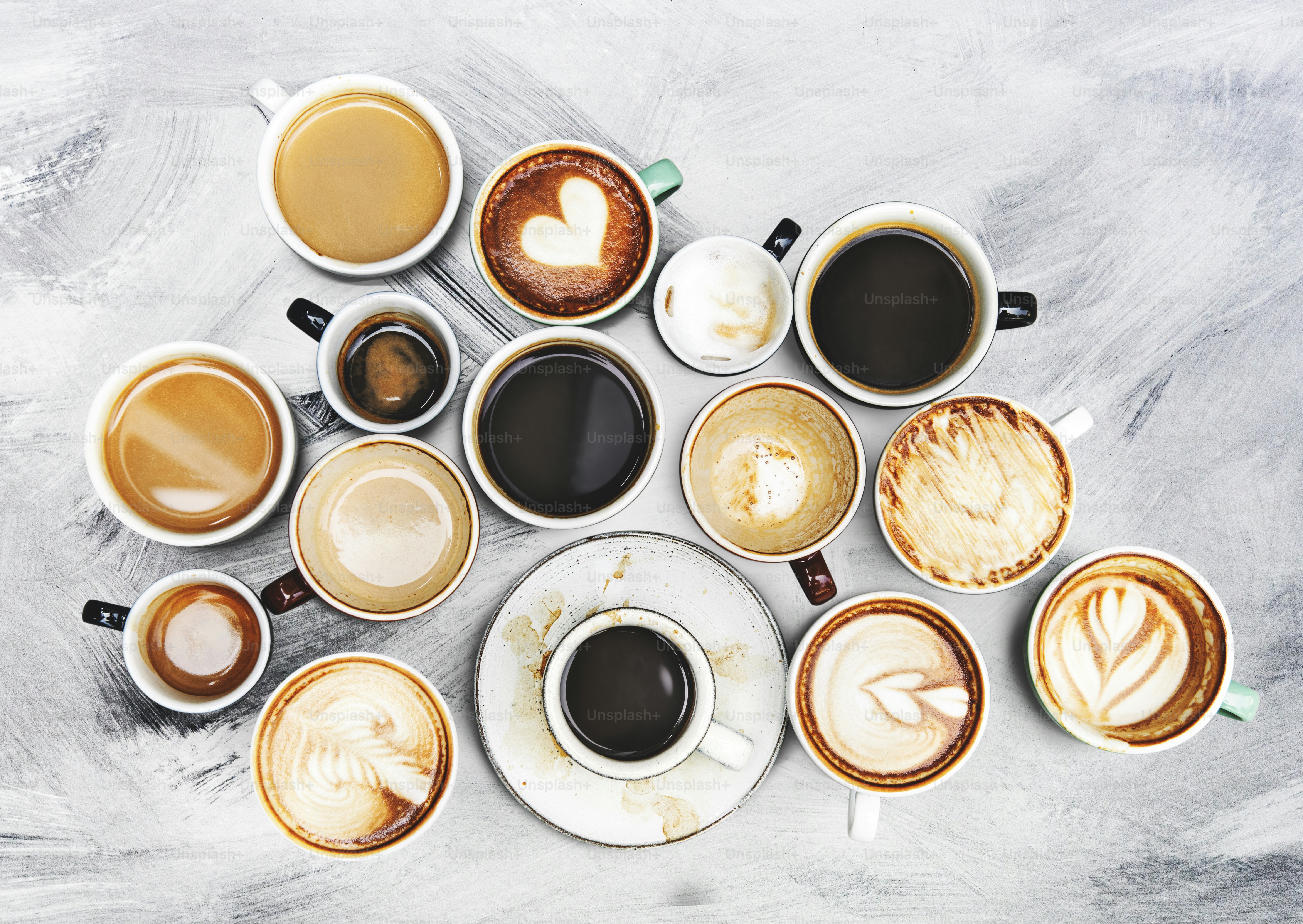 Assorted coffee cups on a textured background