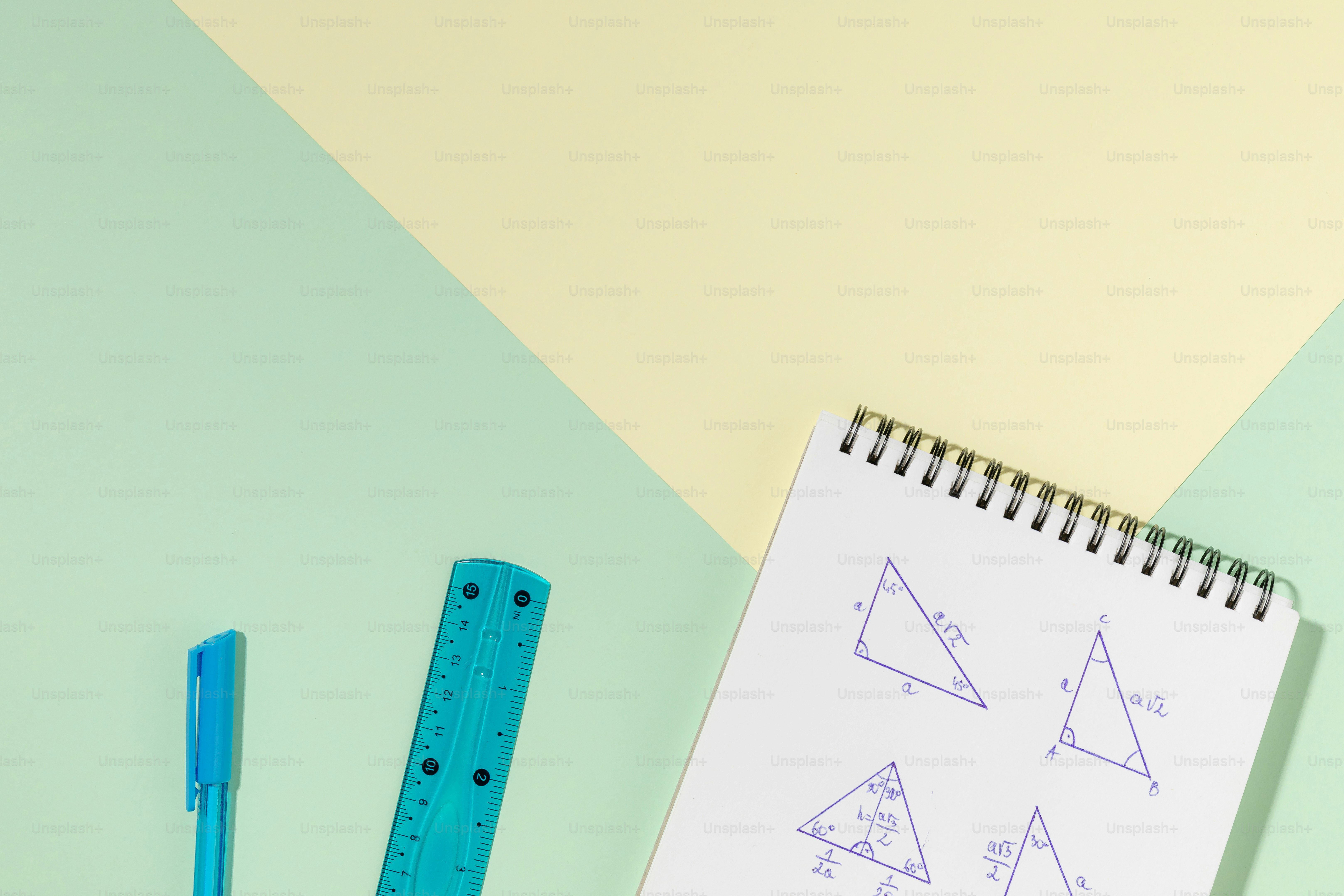 A notebook, ruler, and pencils on a table