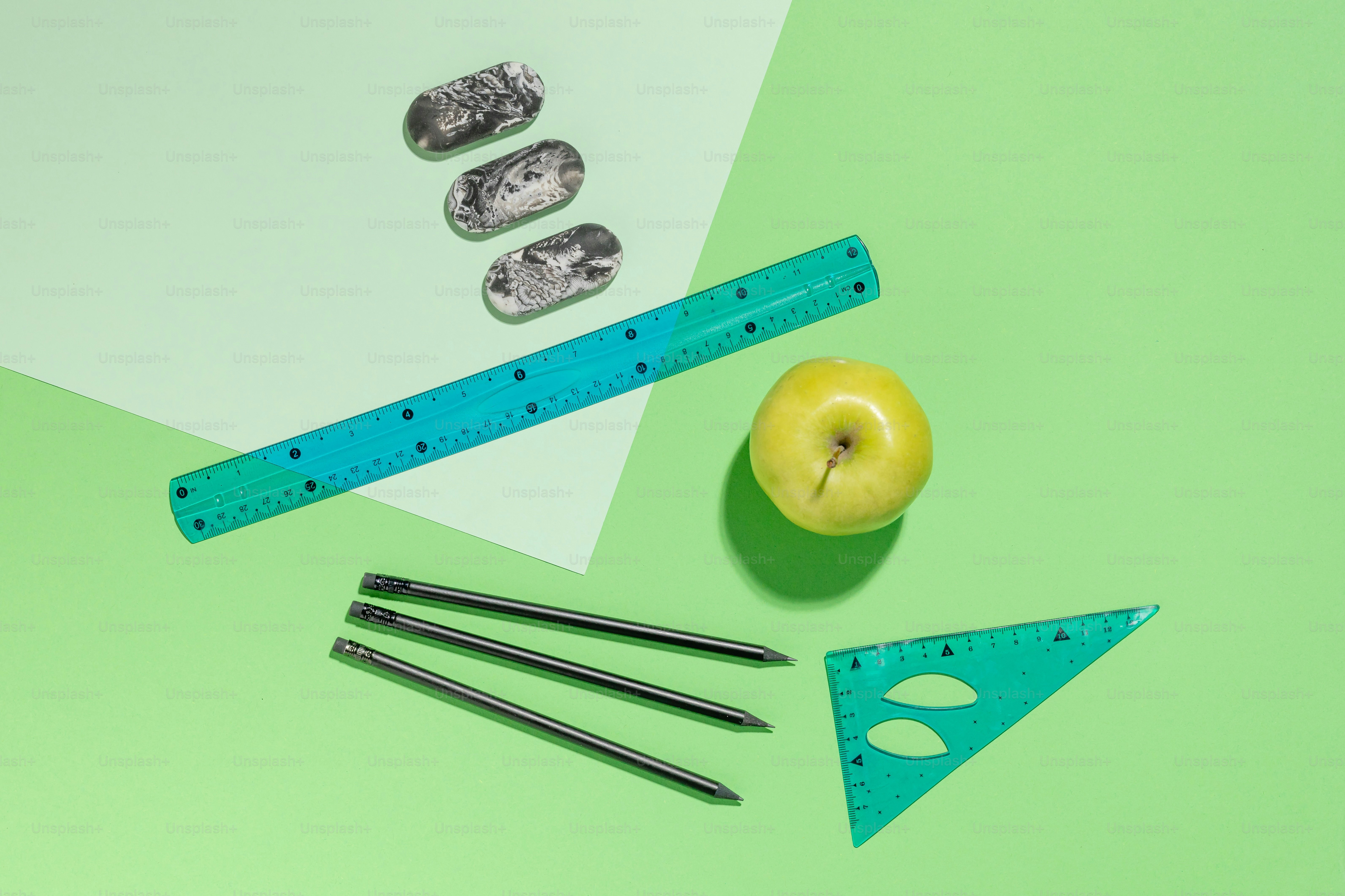 A pair of scissors, an apple, a ruler, and a pair of scissors