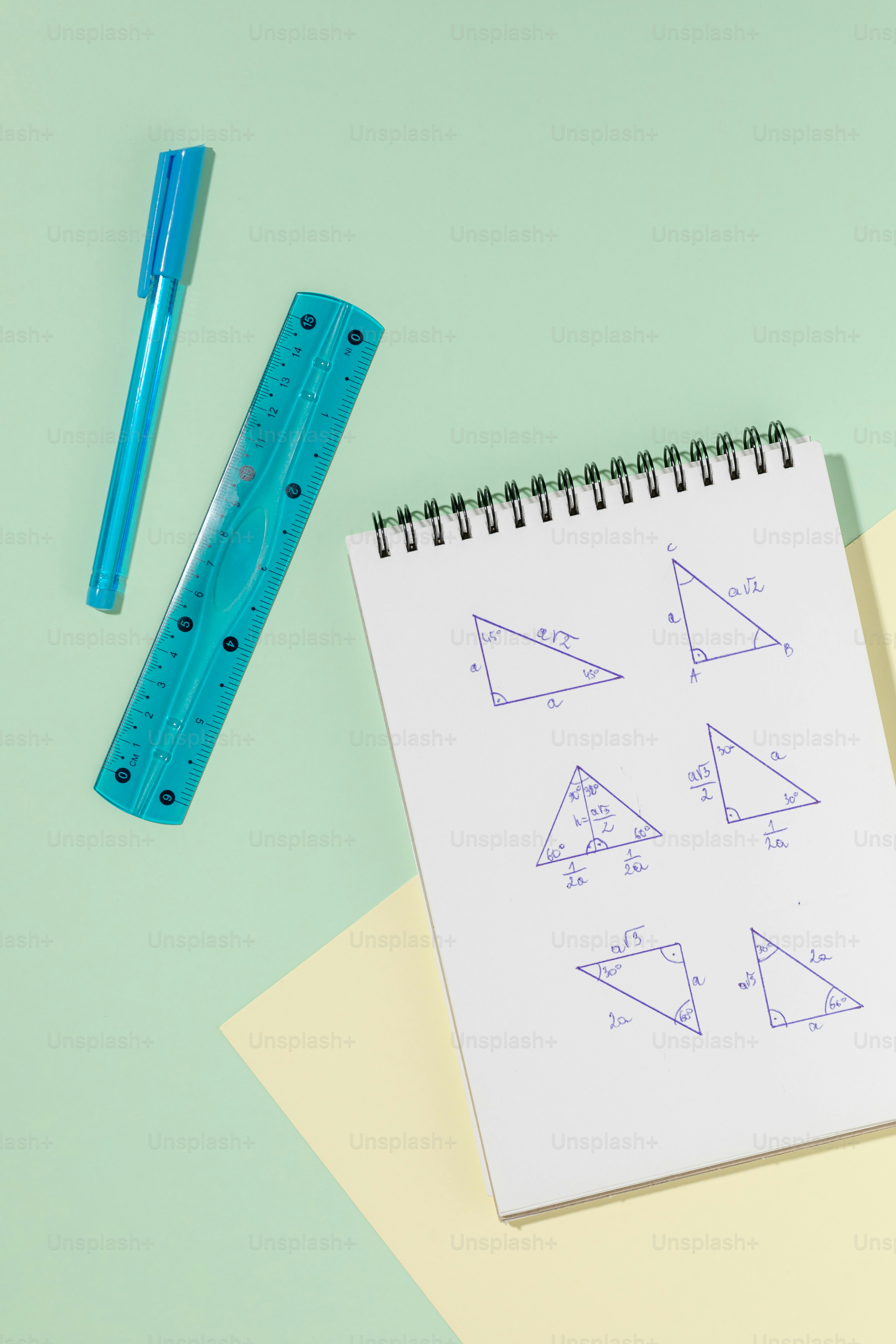 A notebook, ruler, and pen on a table