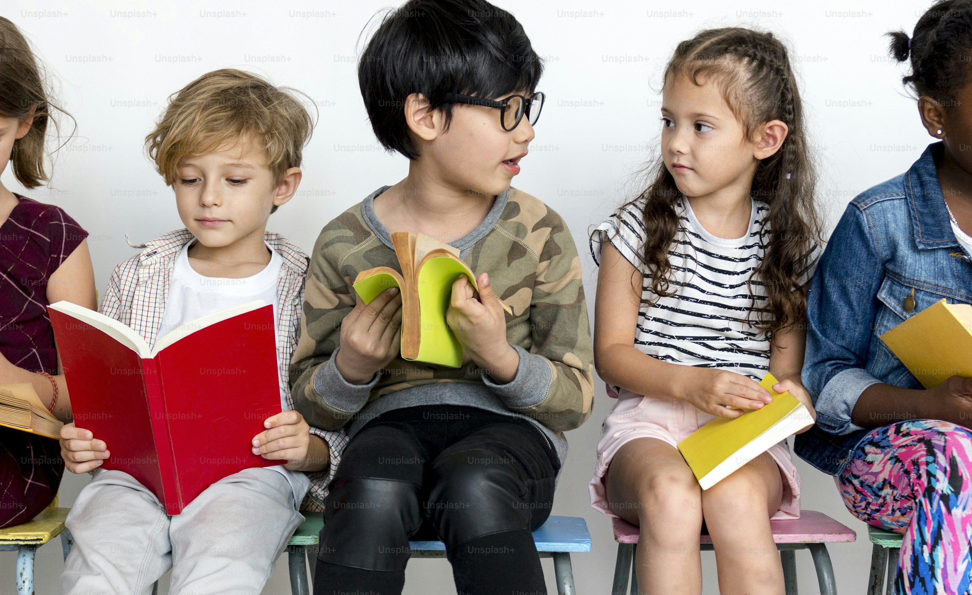 Group of students is sitting and reading a book