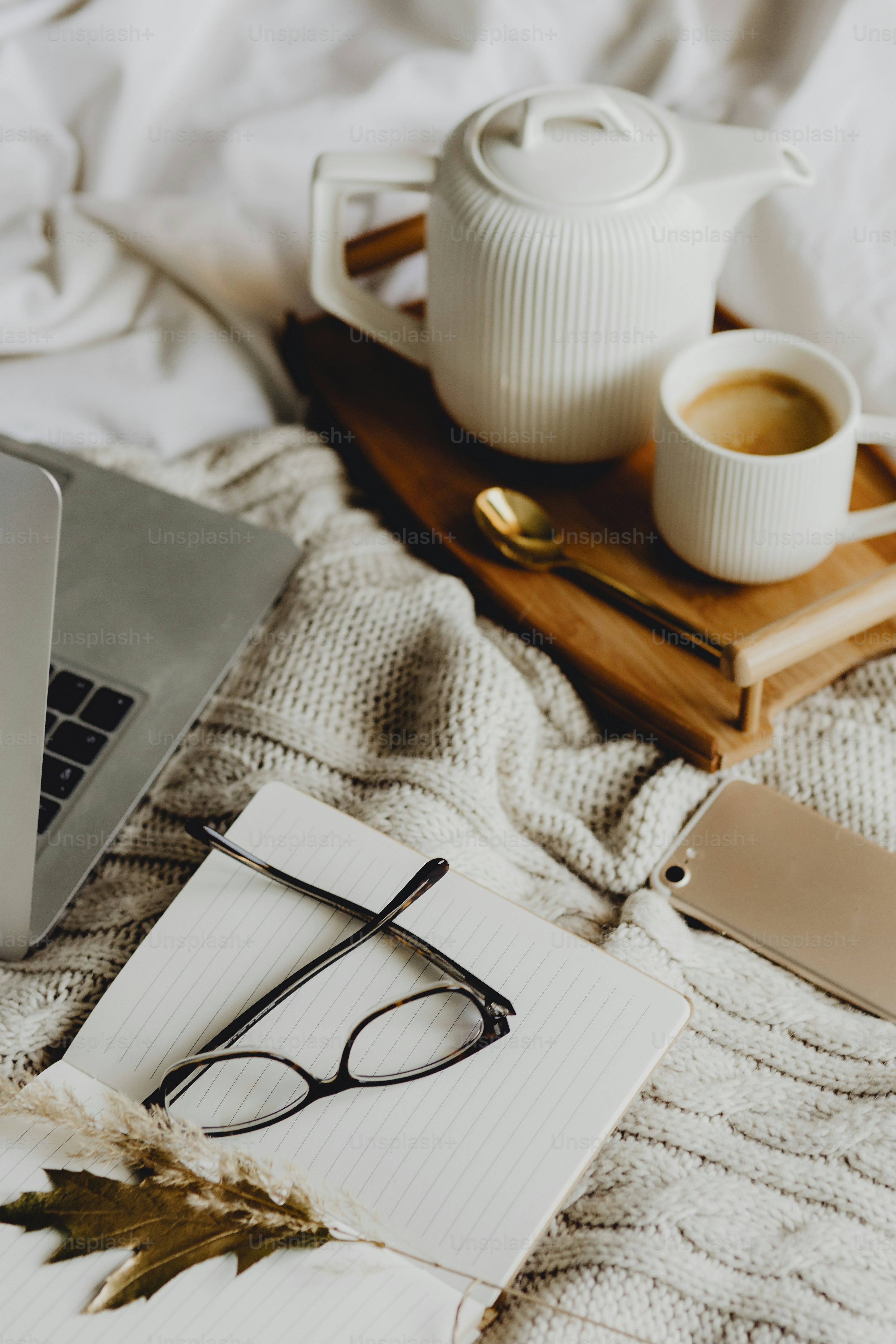 Working in bed with a laptop and coffee