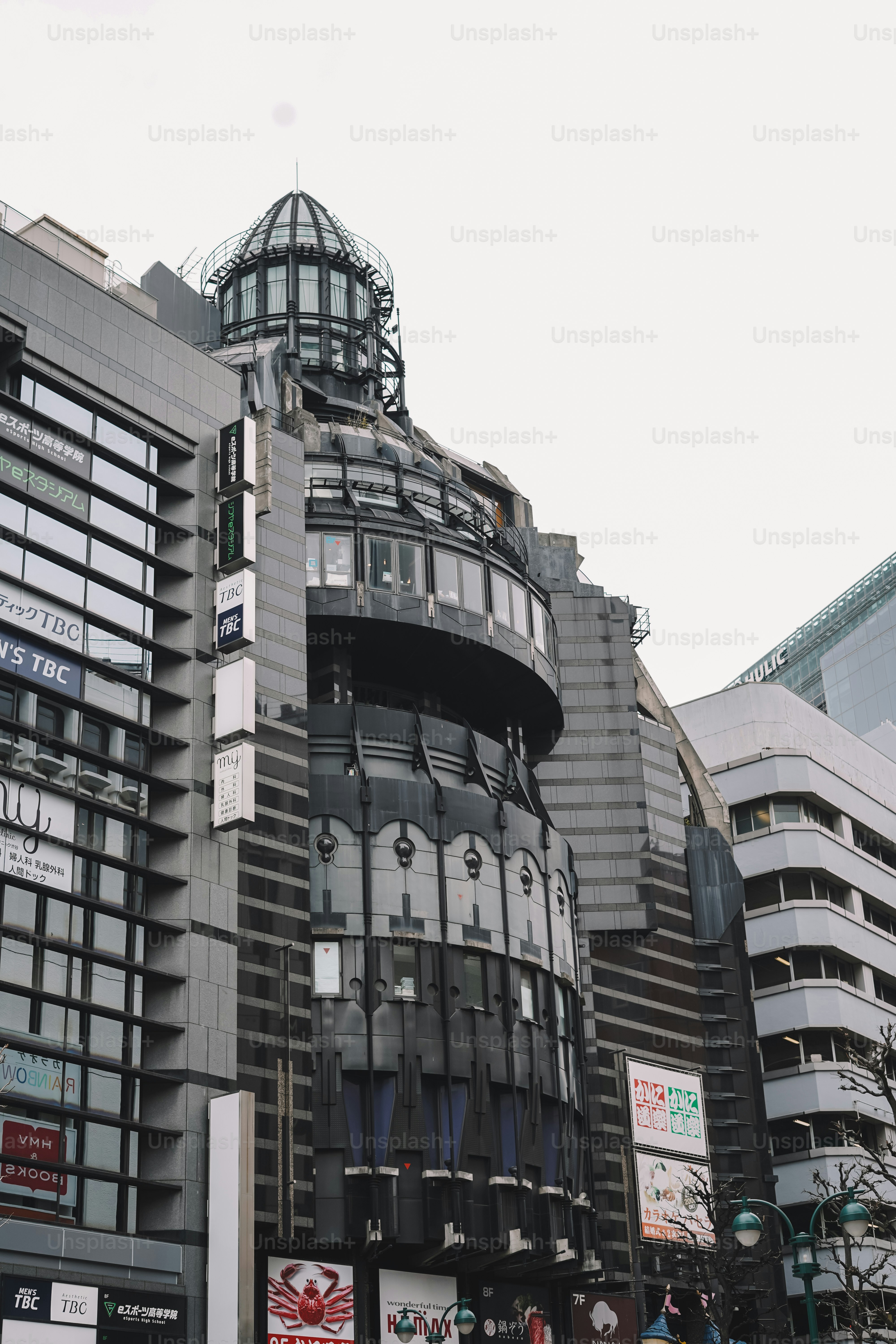 A group of people walking down a street next to tall buildings