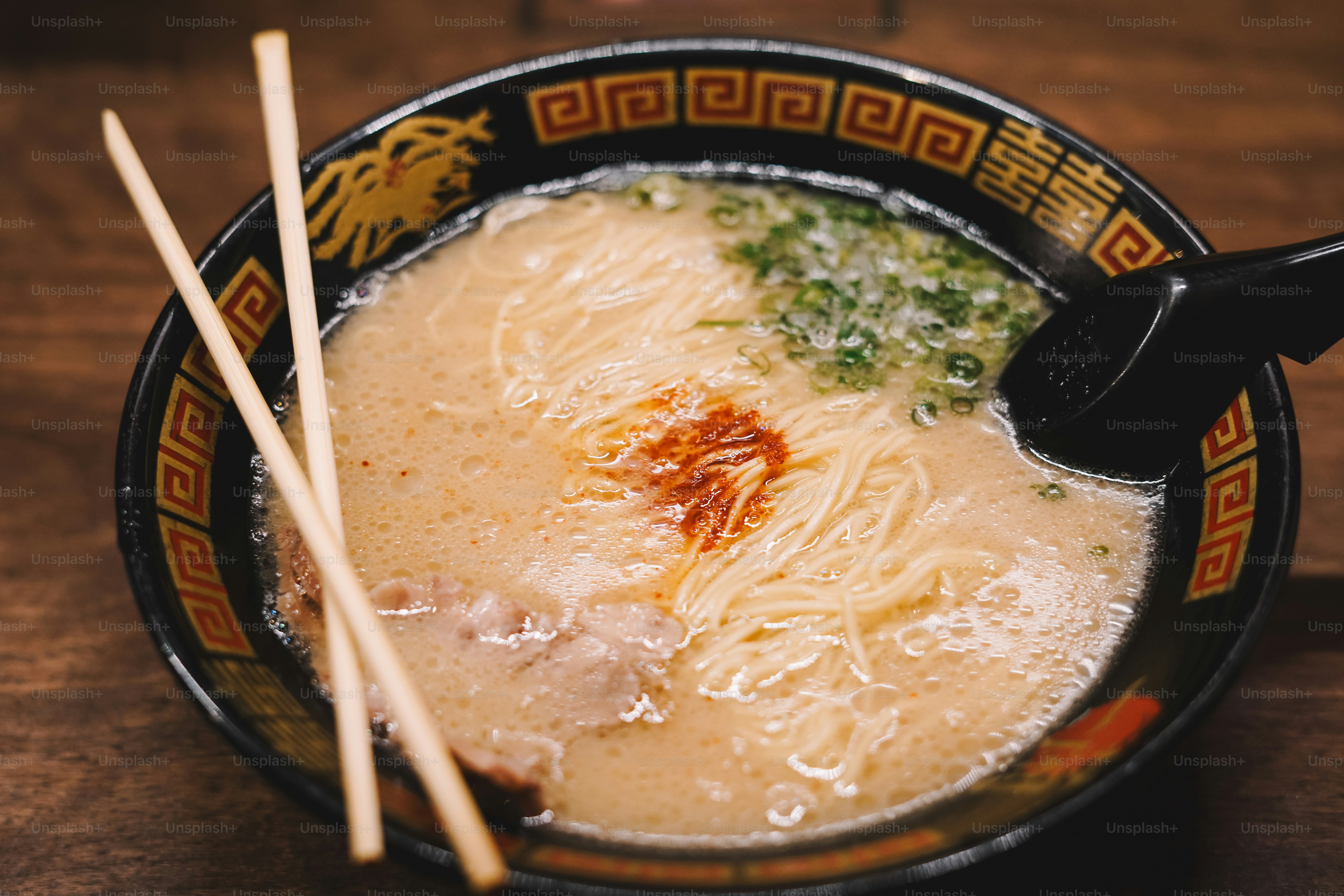 A bowl of soup with chopsticks on a table