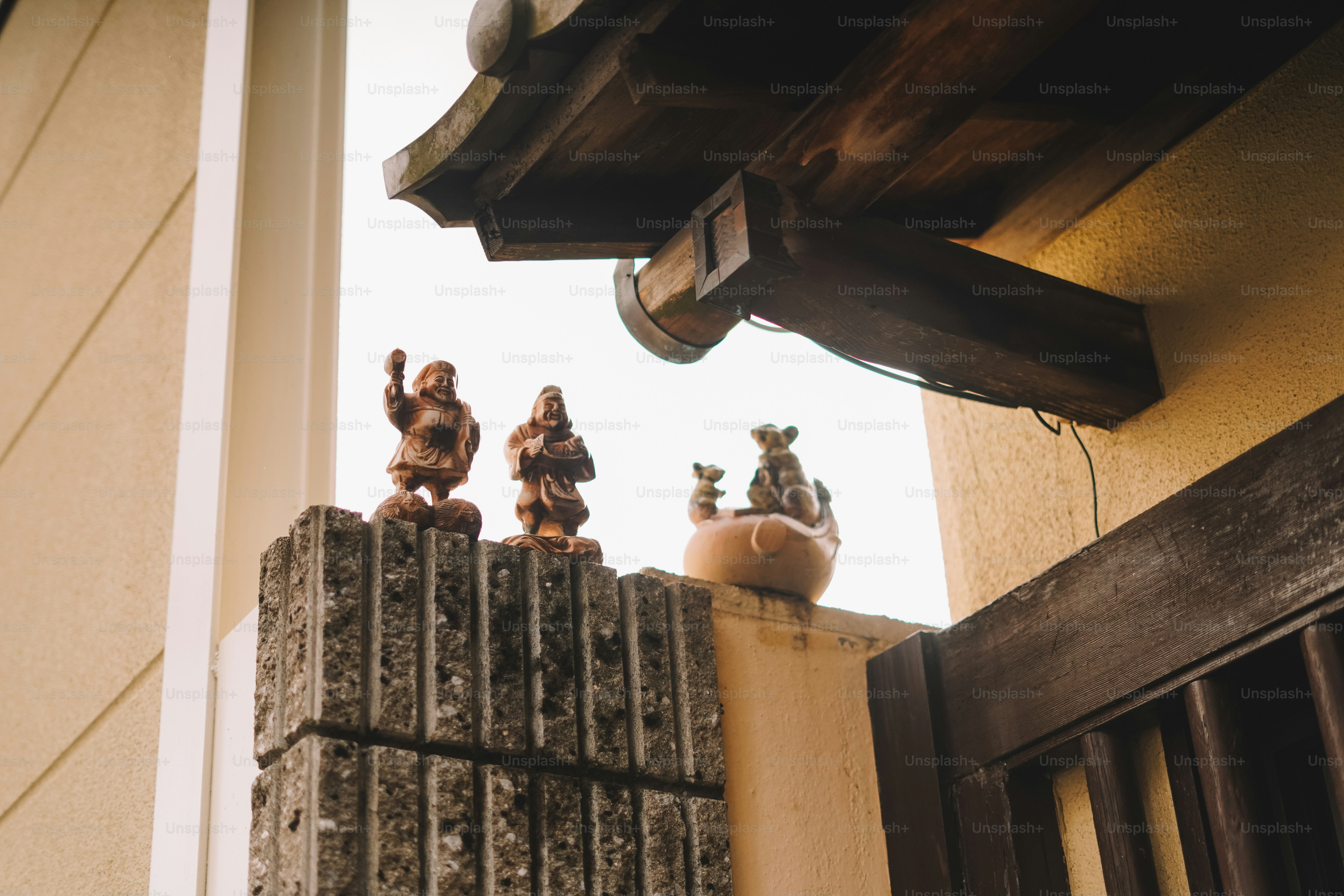 A group of small figurines sitting on top of a fence