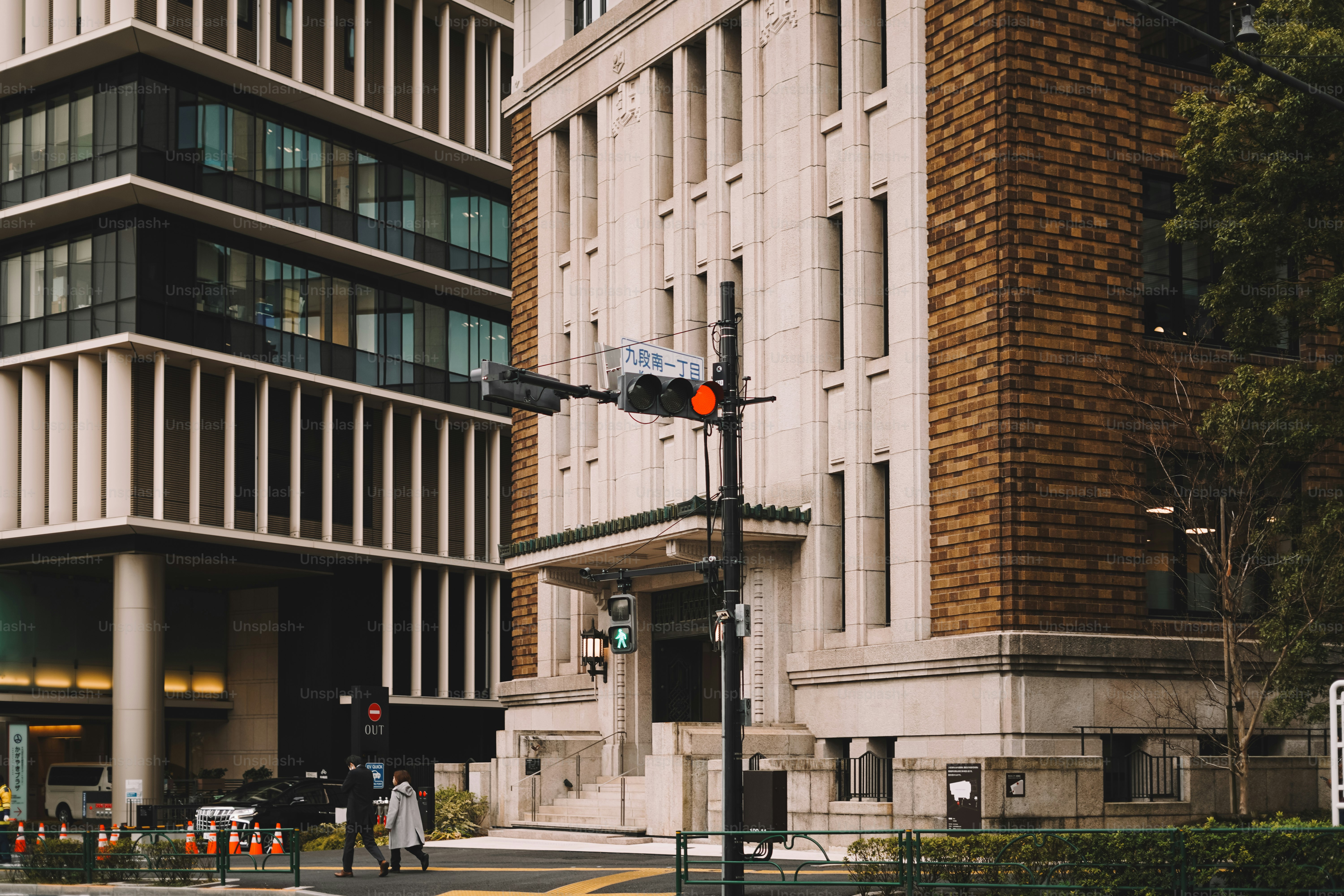 A traffic light on a city street next to a tall building