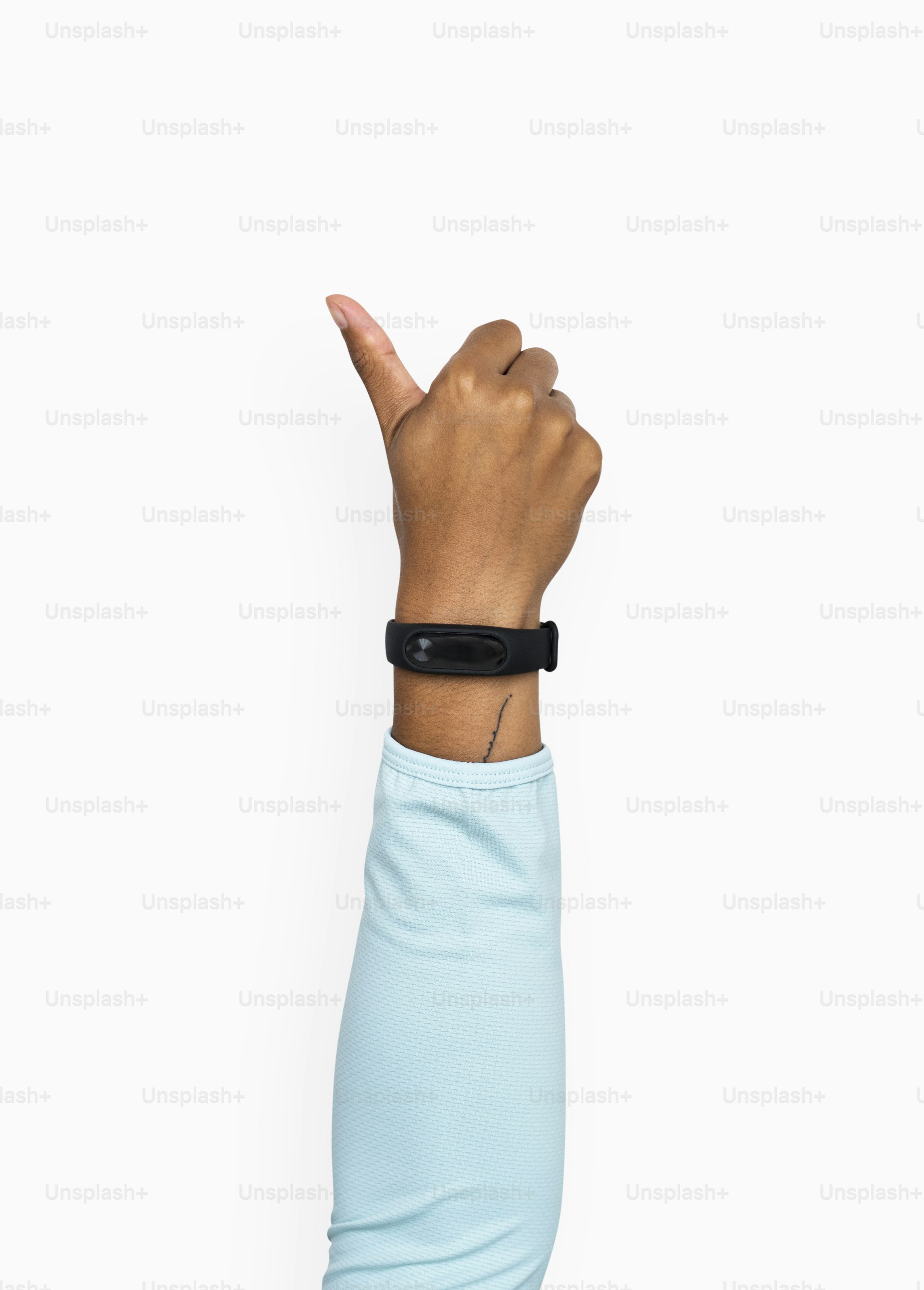 Hand gesturing a thumb up